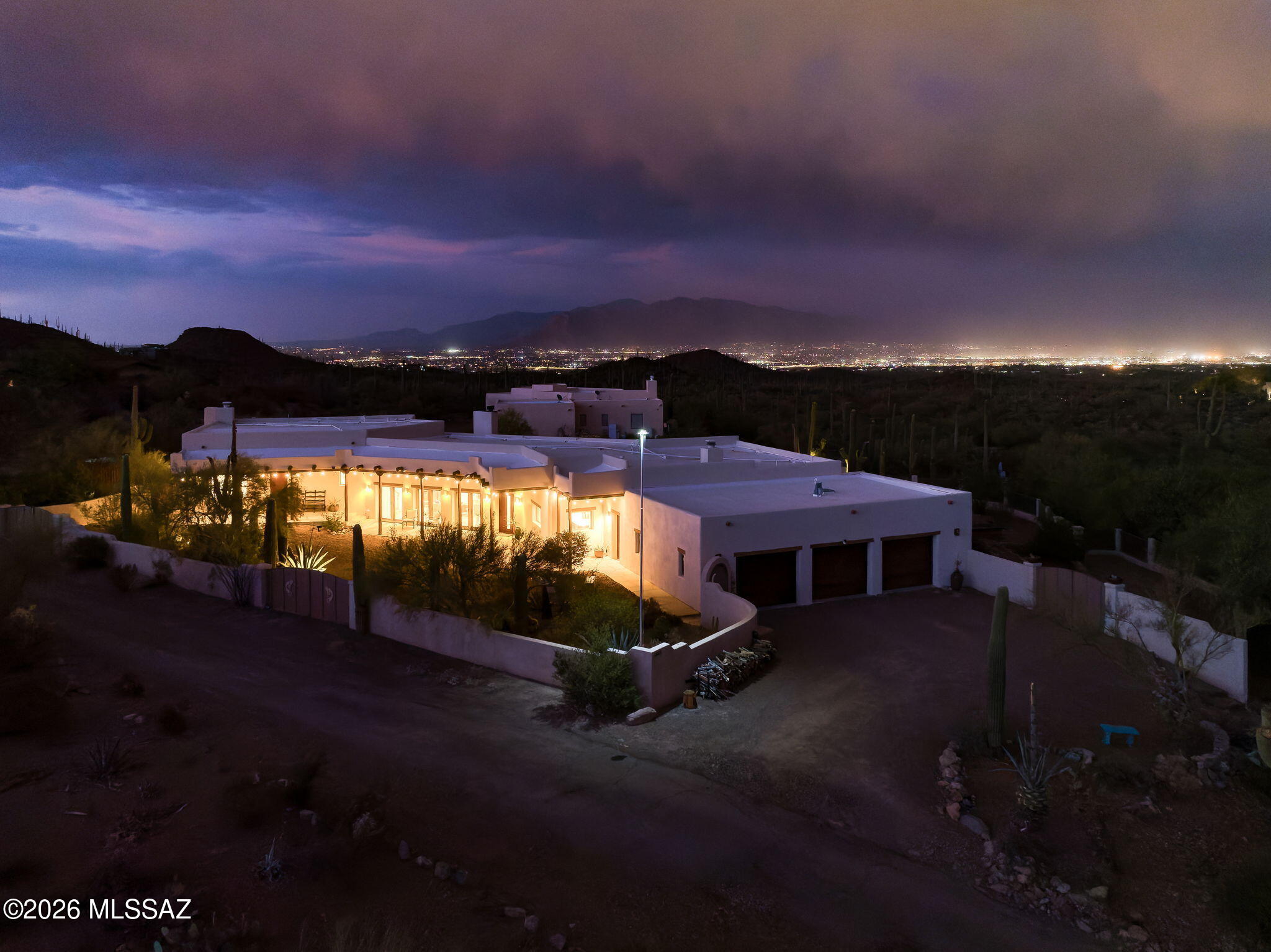 The rush of the city fades to a palpable silence as you wind your way into the foothills of the Tucson Mountains to the Horseback House, where the romance of the Sonoran Desert becomes a part of your daily rhythms. Access to the network of trails that meander their way through nearby Sweetwater Preserve is within walking distance, providing ample opportunity for spontaneous hikes. Inside the home you'll find Southwestern-inspired living at its finest. Warm saltillo tile throughout creates an organic aesthetic and successfully establishes a true sense of the Southwest within the home, further enhanced by the rustic viga beams that span the length of the main living space. Five sets of French doors in both the living space and dining room bathe the interior of the home in natural light while granting views of both the urban sprawl of Tucson below and the soaring peaks of the Tucson Mountains above. The kitchen is an exercise in the skillful balance of both functionality and style, having been fully reimagined under the care of an award winning interior designer. Quartzite countertops crown custom cabinetry while an Ilve range sits beneath a bespoke range hood, and a paneled SubZero refrigerator provides unparalleled performance where it matters most. 
Since 2023 this home has seen its share of upgrades, ensuring smooth operation of systems behind the scenes: the kitchen has been outfitted with a new appliance package (with the exception of the existing SubZero refrigerator), new tankless water heaters furnish hot water on demand, upgraded electrical panels offer enhanced capabilities for your power needs, while new air conditioners provide zoned cooling and maximize energy efficiency. 
A desirable composition of both native desert landscaping and mature fruit trees clothe this over three-acre horse property, creating a balanced + grounded feel in the outdoor living spaces. An extensive ramada and glassy saltwater pool provide year-round outdoor enjoyment just outside your back door, and the lower yard is complete with several raised beds for the gardening enthusiast.
The serenity and solitude to be found at the Horseback House doesn't come at the cost of convenience, you'll find that the University of Arizona is a 30-minute drive away, downtown Tucson 25 minutes, and grocery a short 15 minute trip down the road.
Come experience the lifestyle the Horseback House has to offer today.
