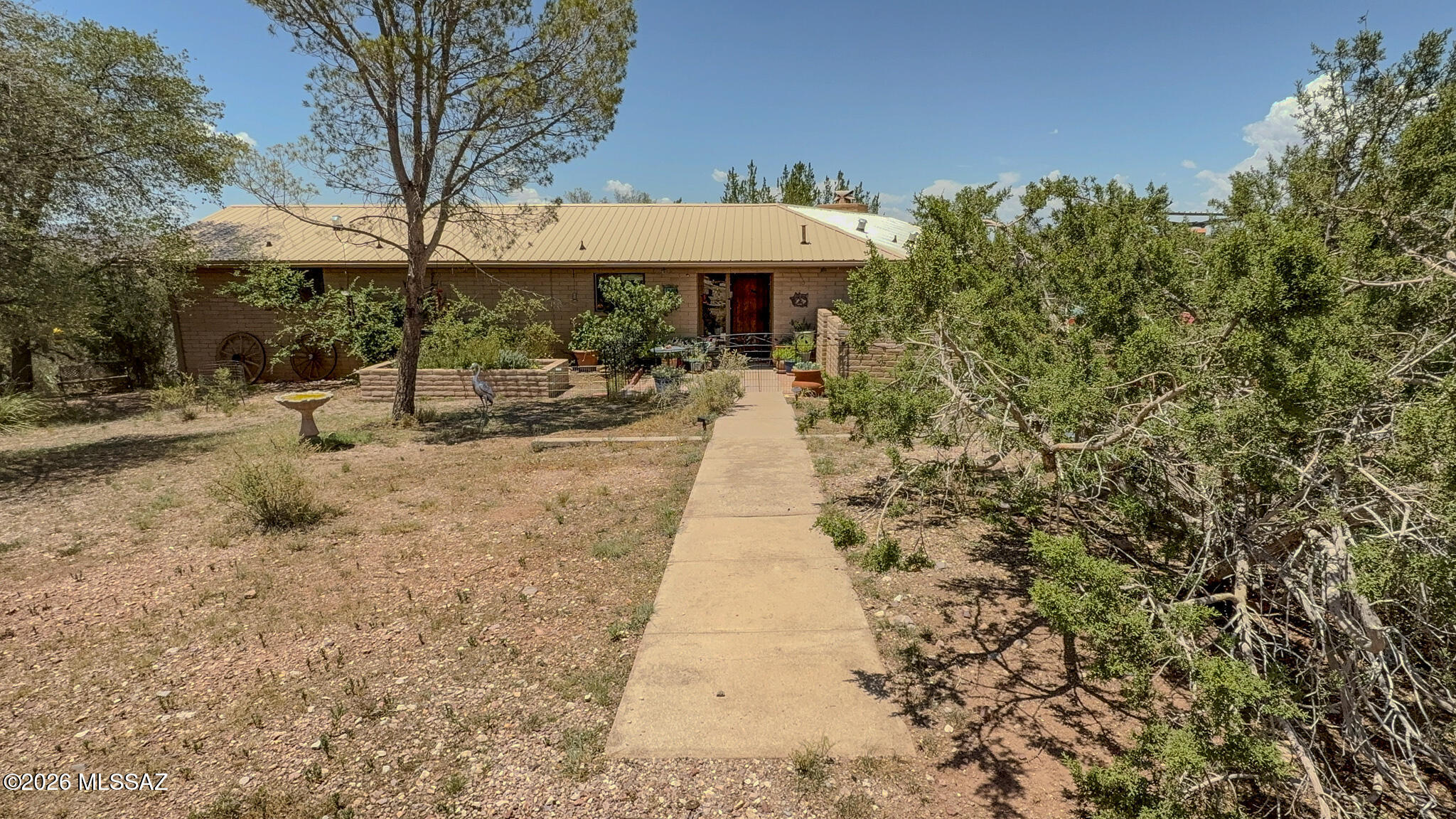 Nestled at the back of the gated Casas Arroyo community, this charming 2-bedroom slump block home offers peace, privacy, and a front-row seat to the natural beauty of Sonoita. The thoughtfully designed floor plan features separate living spaces, a spacious step-down living room, and a new metal roof. Relax on the multi-level back porch while enjoying spectacular sunsets and watching the area's incredible variety of birds, deer, javelina, and other native wildlife. Casas Arroyo offers nearly 200 acres of shared open space, a community pool, and horse stables, creating a unique setting for nature lovers. Just minutes from Sonoita's wineries, restaurants, and scenic grasslands, this is the perfect place to slow down and enjoy Arizona's high desert.