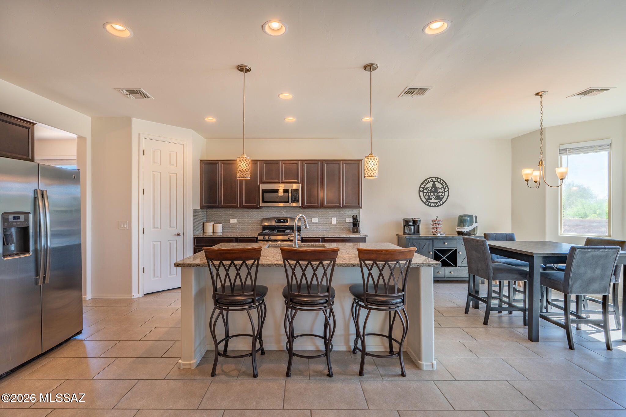 Step into this beautifully designed home featuring a massive great room perfect for entertaining. The large kitchen offers dark cabinets, granite countertops, and a cozy breakfast nook accented by charming bay windows. Enjoy a spacious layout with 3 bedrooms, 2 full baths, plus a convenient powder room, all in a desirable split bedroom plan. Host gatherings in the expansive dining room or relax outdoors under a large ramada overlooking a generous patio with pavers and low-maintenance artificial turf. Take in stunning mountain views from the backyard-this home truly has it all!