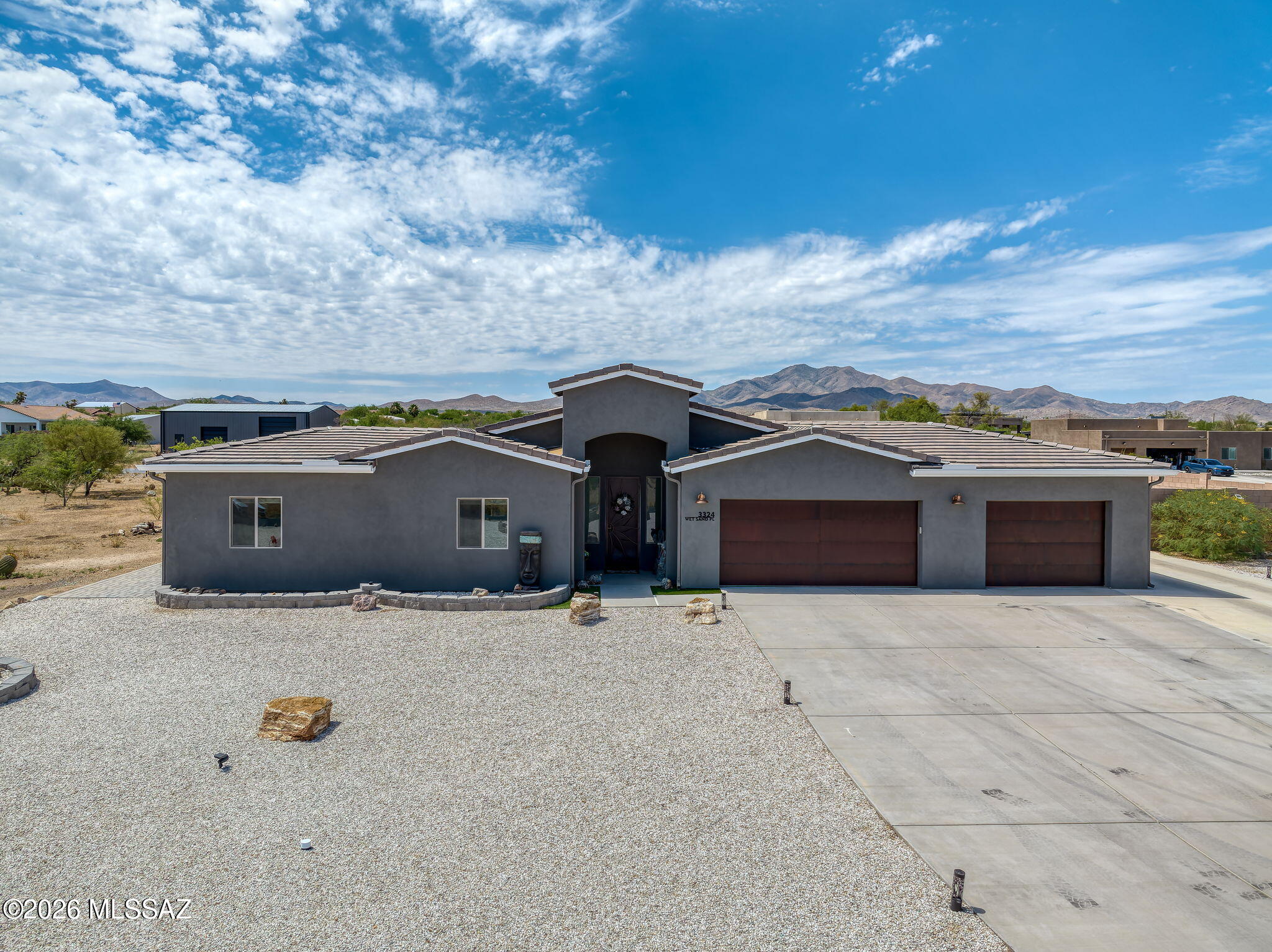 Wide open space, peaceful surroundings and views! Welcome to your new home. Beautifully maintained original-owner home in Whetstone Shadows, built in 2021 and located on a cul-de-sac lot in the Vail School District with no HOA.The spacious residence features plank tile flooring throughout, four bedrooms with walk-in closets. The open concept Great Room floor plan includes a center-island kitchen with espresso soft-close dovetailed cabinetry, granite countertops, and GE stainless steel appliances. The south-facing backyard offers multiple outdoor living spaces, including a covered patio with Santa Rita Mountain views and a paver patio with built-in seating and fire pit. Enjoy views of the Rincon Mountains,  colorful Arizona sunrises and sunsets, & exceptional stargazing. The expansive yard allows additional space for play, gardening or adding a pool! 
Pride of ownership is evident throughout with numerous seller upgrades, including a water softener and reverse osmosis system, custom security door, custom metal gates, seamless gutters, window and door treatments throughout, epoxy-coated 3-car garage floor, extended concrete driveway, and an increased block wall height for added privacy. Outdoor living shines with artificial turf in the front and back side yards, extensive decorative gravel landscaping, and a custom paver patio complete with a fire pit and large built-in bench. Diamondback Roofing completed preventative roof maintenance in June 2026, adding to the home's exceptional condition and move-in-ready appeal. Modern construction, meticulously maintained, mountain views, acreage, and a peaceful setting combine to create a property that feels removed from the hustle of the city while remaining convenient to everything Vail has to offer. Make this your home sweet home today!