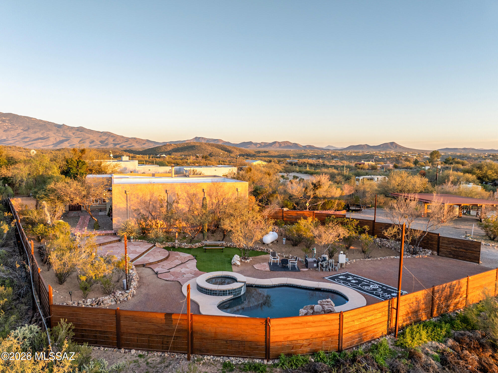 Views. Location. Pure Tucson character. From the moment you step through the charming courtyard entry, you know this one is special. Inside, enter at the great room with soaring ceilings, Saltillo tile and cozy fireplace - an immediate statement, with natural light pouring in and space that feels both grand and welcoming.  The kitchen shines with granite countertops and flows effortlessly into the dining and living areas — perfect for gathering, entertaining, or simply enjoying everyday life. Generously sized bedrooms offer comfort for everyone, while the primary suite steals the show with stunning desert views, private patio, a spa-style bath with soaking tub, separate shower, dual vanities, and a custom walk in closet that absolutely delivers.  Need flexibility? You've got it.  (more) fully finished studio with its own private entrance opens the door to endless possibilities  guest suite, home office, creative space, gym, or multigenerational living.  Step outside and the lifestyle gets even better. Cool off in the 4-year-old PebbleTec pool, unwind in the spa, enjoy the tranquility of the waterfall feature, and enjoy the privacy and space this property offers- operate it all from your phone app! There's even gated RV parking with electric hookup. Horse lovers  you're covered too. A horse corral is ready to go, and you're just minutes from the Saguaro National Park Loma Alta Trailhead for hiking, horseback riding, and cycling adventures right out your door. And let's talk GARAGE A 4+ car tandem garage (1075 sq ft) with 220 power  a dream setup for projects, tools, storage, or serious hobby space.
Big views. Endless flexibility. Outdoor adventure at your doorstep.
This is Tucson living at its absolute best