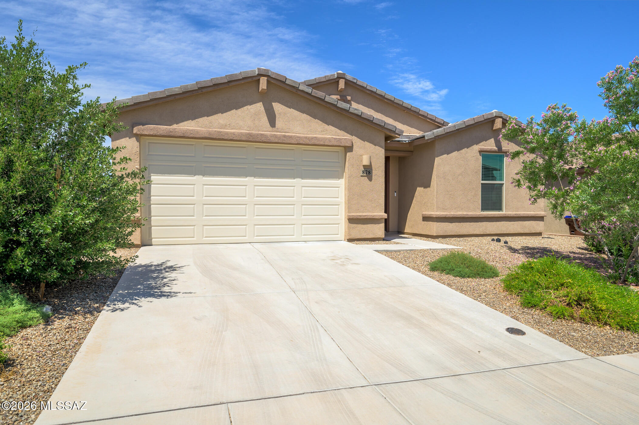 Welcome home to modern comfort and vibrant community living! This charming single-family residence offers a spacious and versatile layout perfect for today's families. With three bedrooms, a den, and two full bathrooms, there's room for everyone to have their own space and enjoy. The inviting open floor plan features stylish wood-look plank flooring throughout the main living areas, adding warmth and durability.  The contemporary kitchen is a chef's dream, boasting crisp white cabinets with crown molding, striking black granite countertops, stainless steel appliances, and a generous pantry. Enjoy casual meals or entertaining around the island, beautifully illuminated by elegant glass pendant lights. Retreat to the serene primary suite, complete with a double-sink vanity and a sleek, low-maintenance shower enclosed by glass doors.  Step outside and let your creativity flourish--design the backyard oasis that suits your family's needs. As a resident of Rancho Sahuarita, you'll have access to unparalleled amenities, including pools, a splash park, a fitness center, walking trails, playgrounds, fishing lakes, and a vibrant kids' club. Experience a thriving, friendly neighborhood where you can build lasting memories and lifelong friendships. This is more than a home--it's a lifestyle your family will love!