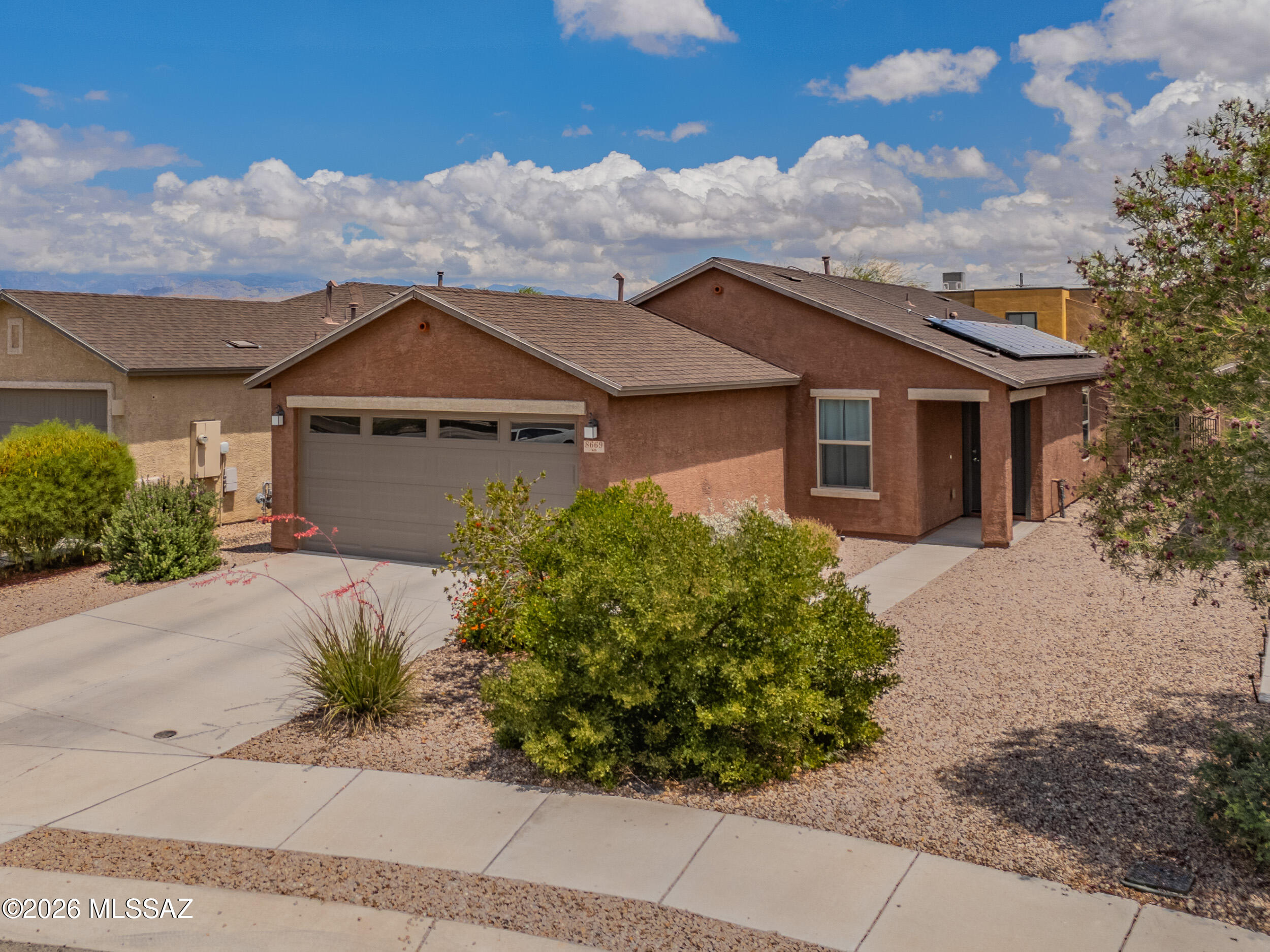 Bright & spacious 3 bed/2 bath home built in 2020 with FULLY OWNED SOLAR PANELS! Open concept layout with tile and carpet flooring, open kitchen with moveable island, walk-in pantry, modern appliances, and water softener. Multiple walk-in closets, recessed lighting, smart thermostat, and ceiling fans throughout. Covered backyard patio with desert landscaping, plus a 2-car garage with extra guest parking. Located at the end of a cul-de-sac in SE Tucson with easy access to shopping, dining, parks, and medical services. Just 12 mins from Saguaro National Park!