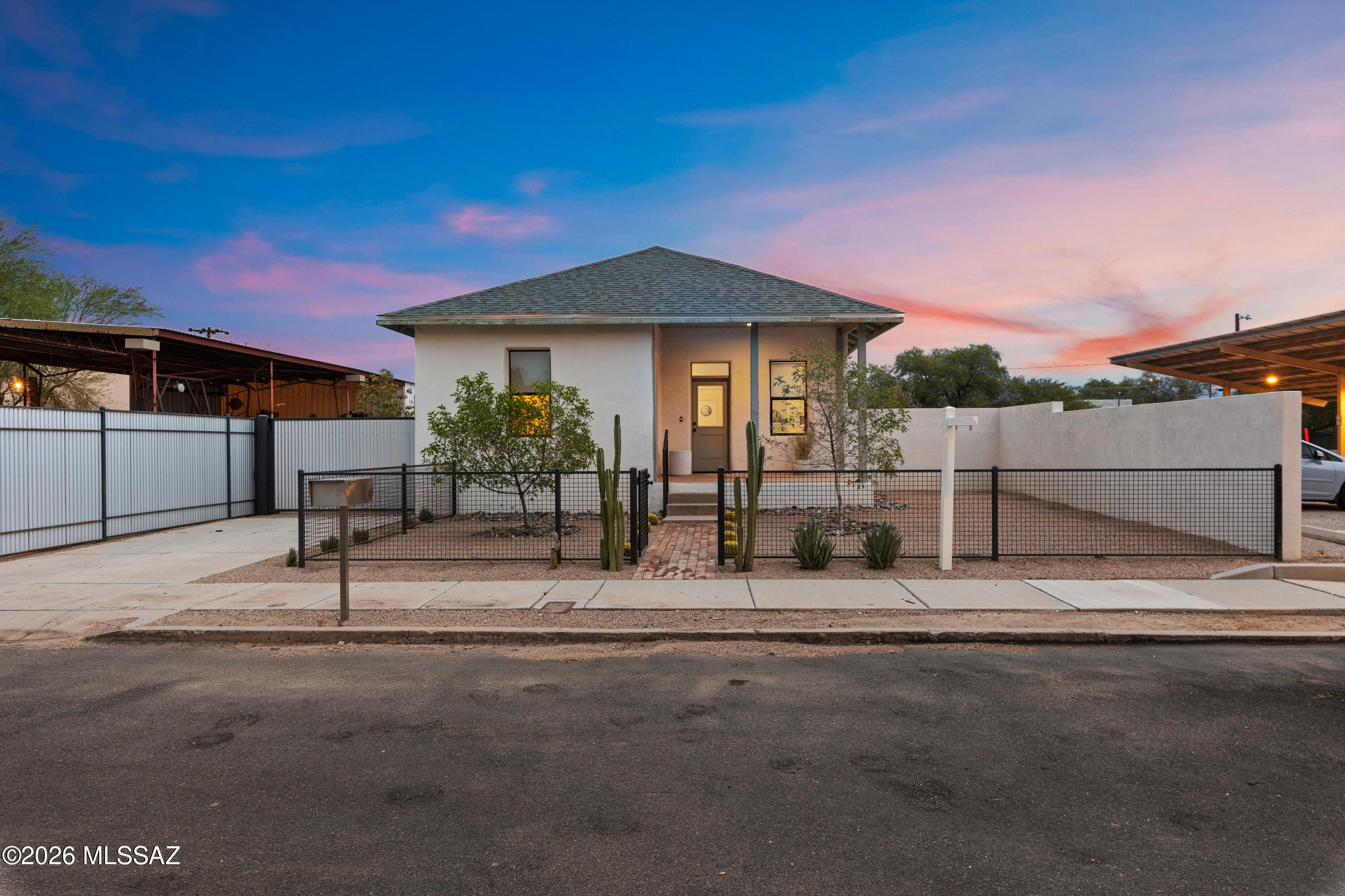 Discover the perfect blend of historic character and modern living in the heart of Tucson's iconic Lost Barrio. Originally built in 1912 and thoughtfully reimagined in 2022, this beautifully renovated home offers stylish, comfortable, and functional living while preserving its timeless appeal. The standout feature is the expansive detached four-car storage building, offering endless possibilities as a workshop, home gym, studio, commercial workspace, or secure storage. Whether you're seeking a unique primary residence, live/work opportunity, or investment in one of Tucson's most vibrant historic districts, this exceptional property offers unmatched versatility and potential.