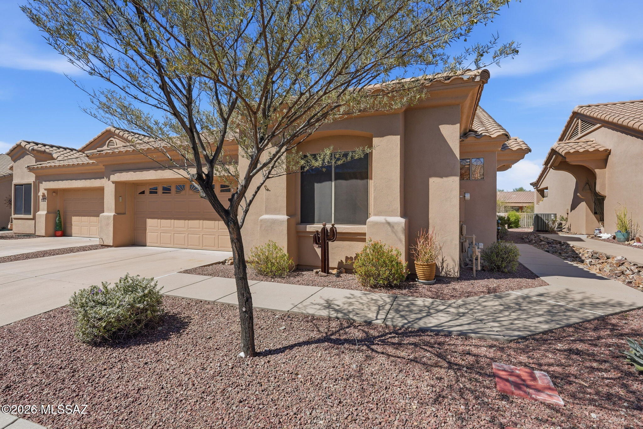 Welcome to this beautifully maintained Chula Vista model, being sold turn-key, offering 2 bedrooms, 2 baths, a den, and 1,593 sq ft on a premium lot backing to a tranquil wash for added privacy and serene desert views. The open great room floor plan features a cozy gas fireplace, tile and wood flooring, custom paint, and subtle Southwest charm throughout. The kitchen flows seamlessly into the main living area, ideal for entertaining or everyday living, while the den offers flexible space for an office or hobbies. Enjoy resort-style amenities including pools, spa, fitness center, library, billiards, and a vibrant social scene. HOA covers water, sewer, trash, cable, exterior maintenance, roof, pest control, and more. Roof underlayment has been replaced.