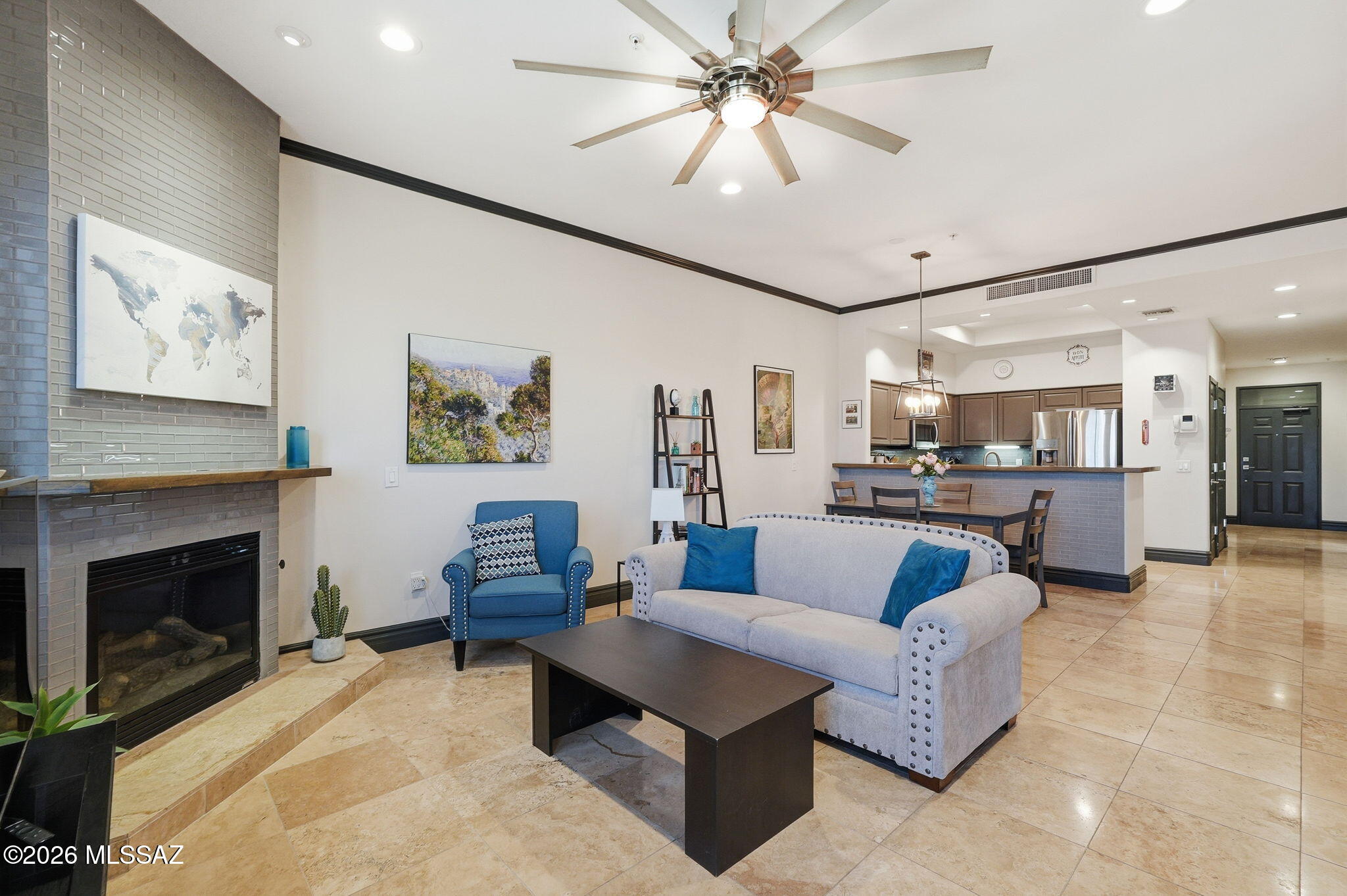This condominium offers a blend of modern elegance and comfort. In the Sam Hughes neighborhood and close to U of A. The kitchen is equipped with granite countertops and stainless-steel appliances, complemented by a convenient breakfast bar for casual dining or entertaining.
The unit includes two primary suites. Both feature dual vanities with granite countertops and relaxing soaking tubs.
There is also a powder room for guests. The living areas showcase stylish tile flooring, while the bedrooms have  carpeted floors for added warmth. A laundry closet, with stackable washer and dryer, adds practical convenience. The HVAC system was replaced in 2022. A gas fireplace enhances the living space with warmth and ambiance, From the spacious patio, you can enjoy views of the 
U of A stadium, 'A' mountain, city lights and breathtaking sunsets, offering a  picturesque and vibrant setting. HOA covers water, gas, security, roof, and exterior and common area maintenance. Two reserved covered parking spaces are located south of the unit. Near Banner Hospital. Come and see all that Sam Hughes Place at the Corner has to offer.