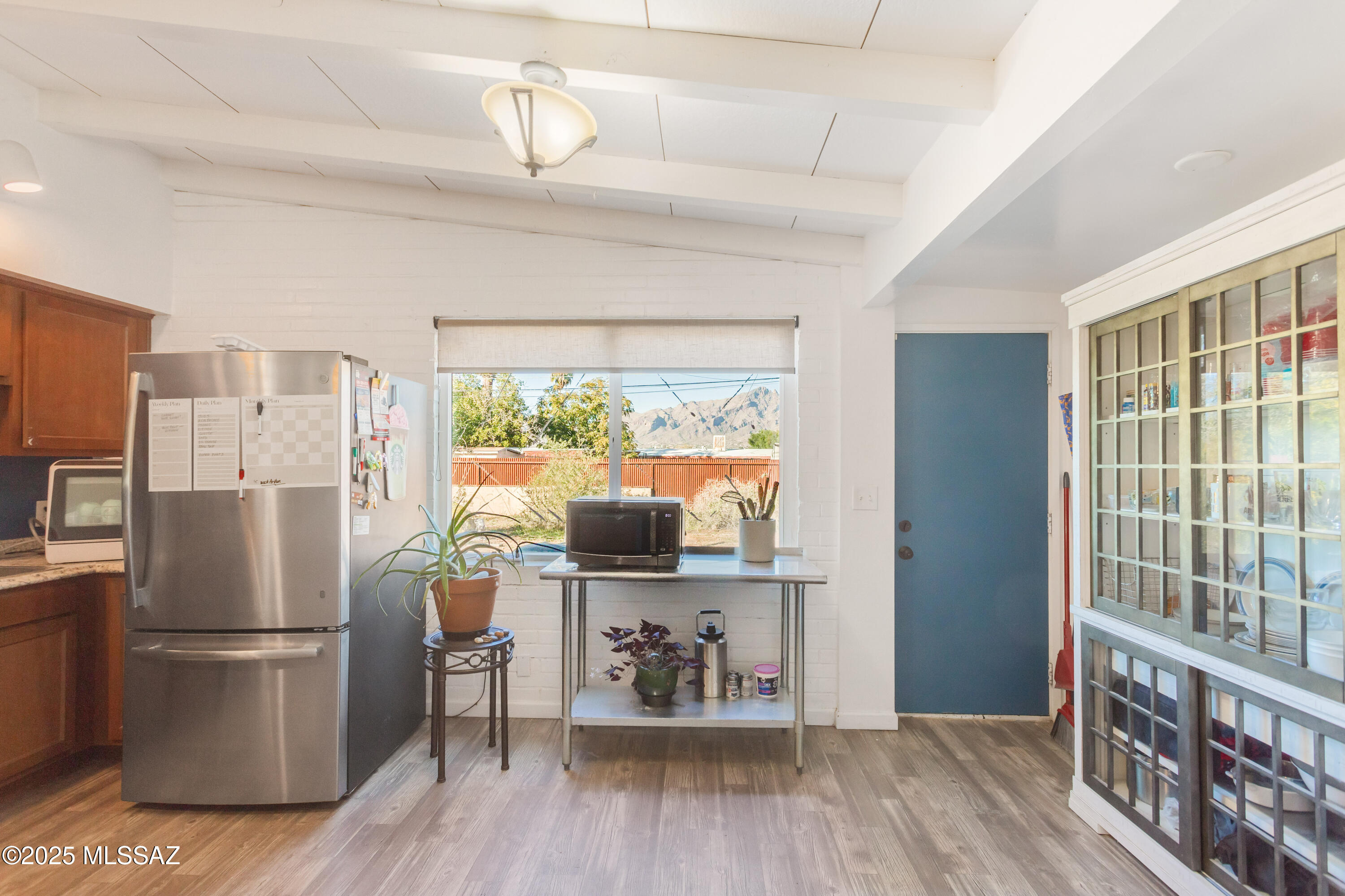 Lender-paid rate buydown available! This 3-bedroom, 2-bath home offers an open-concept living, dining, and kitchen area with vaulted wood-beam ceilings, plus a bonus second living space that can function as a TV room, gaming area, study, or guest room. Enjoy beautiful Catalina Mountain views from both inside the home and the backyard. The current owners have upgraded the electrical system, installed a Rinnai tankless water heater, added corrugated steel fencing with a 16.5-foot sliding gate for rear alley access, completed roof repairs, and installed a security system. The large, flat yard features desert landscaping and offers endless potential for a garden, play space, pool, hot tub, or ADU (R2 zoning). Additional features include an attached enclosed laundry room with ample storage, side and back patios, and a storage shed. All set in a quiet neighborhood close to Davidson Elementary School, The Loop, Brandi Fenton Memorial Park, Bashas, Lighthouse YMCA, and more. No HOA.