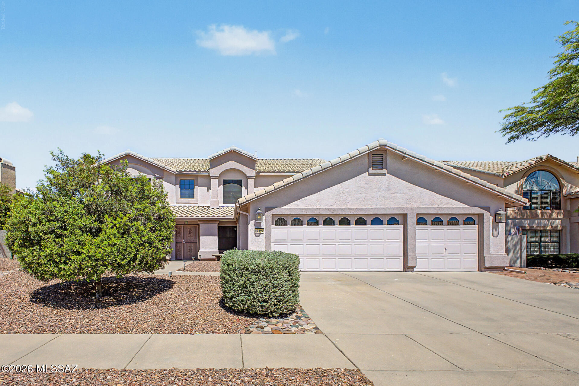 Wake up to breathtaking Catalina Mountain views in this beautifully updated Rancho Vistoso home featuring 3 bedrooms, 3 bathrooms, a flexible loft, den, and an oversized 4-car garage. Bright, open living spaces are enhanced by wood-look flooring, plantation shutters, and abundant natural light. The spacious kitchen is designed for everyday living and entertaining with granite countertops, stainless steel appliances, a center island, pantry, ample cabinetry, and a sunny breakfast nook. Upstairs, the private primary suite offers vaulted ceilings, a walk-in closet, soaking tub, and private balcony with stunning mountain views. The backyard is an outdoor retreat with a covered patio, paver seating areas, putting green, and room to relax or entertain. Close to parks, golf, hiking and shopping.