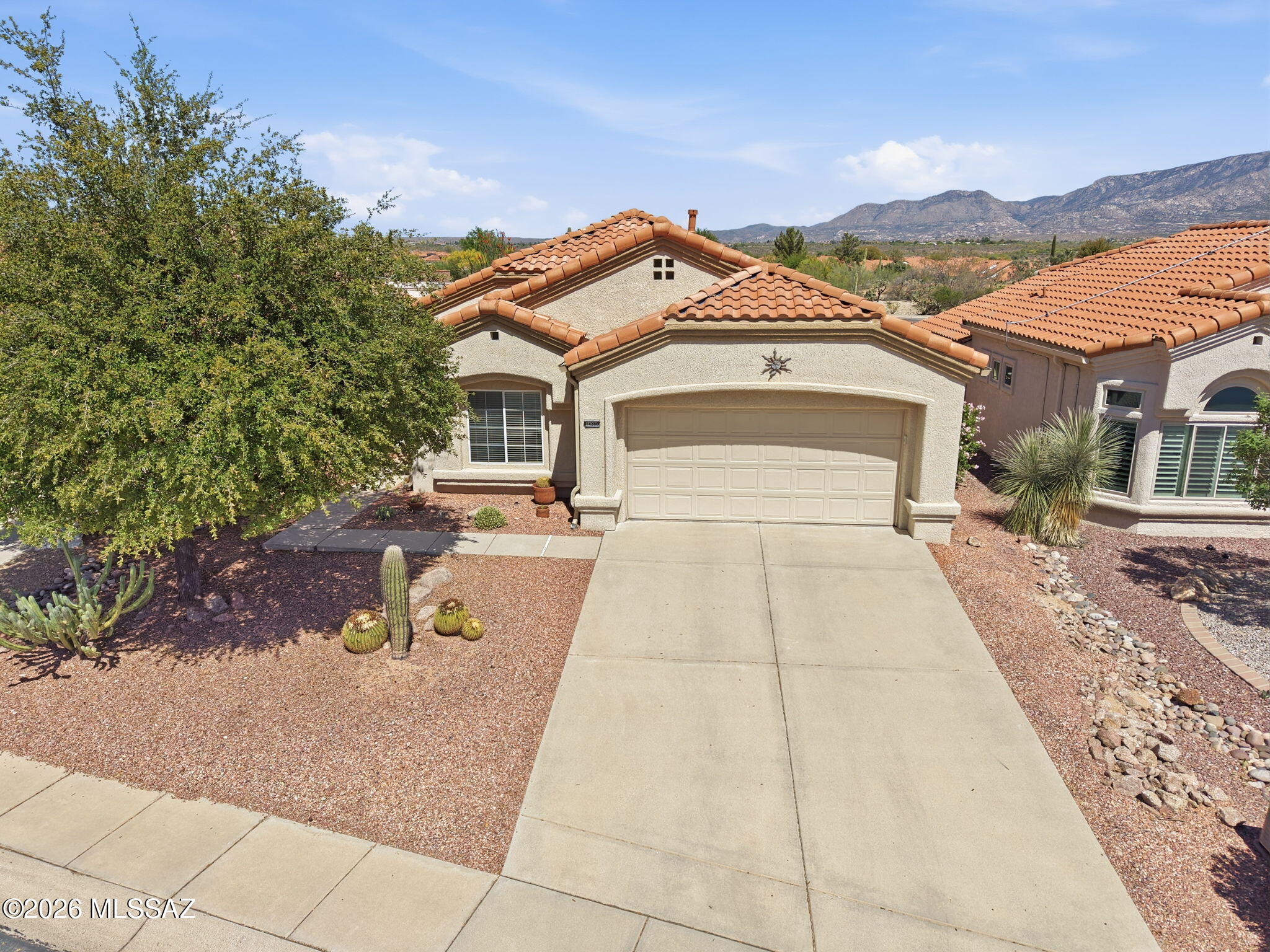 Sun City Oro Valley home with spectacular Catalina Mountain views! This 2 bedroom, 2 bath Montara model offers 1,298 sq ft with a desirable split bedroom floor plan and a warm, inviting feel. The east-facing backyard
captures beautiful sunrises and peaceful mountain views. The updated kitchen features stainless steel appliances,
while tile and luxury vinyl flooring run throughout. Enjoy Arizona living at its best on the extended back patio with ramada, perfect for entertaining or relaxing while taking in the scenery. Located in the highly sought-after Sun City Oro Valley active adult community with golf, pools, fitness center, clubs, and endless activities. HVAC approx. 2016. Roof replaced 2019. This home being sold turn-key, everything in the home is included, furnishings, art, etc.