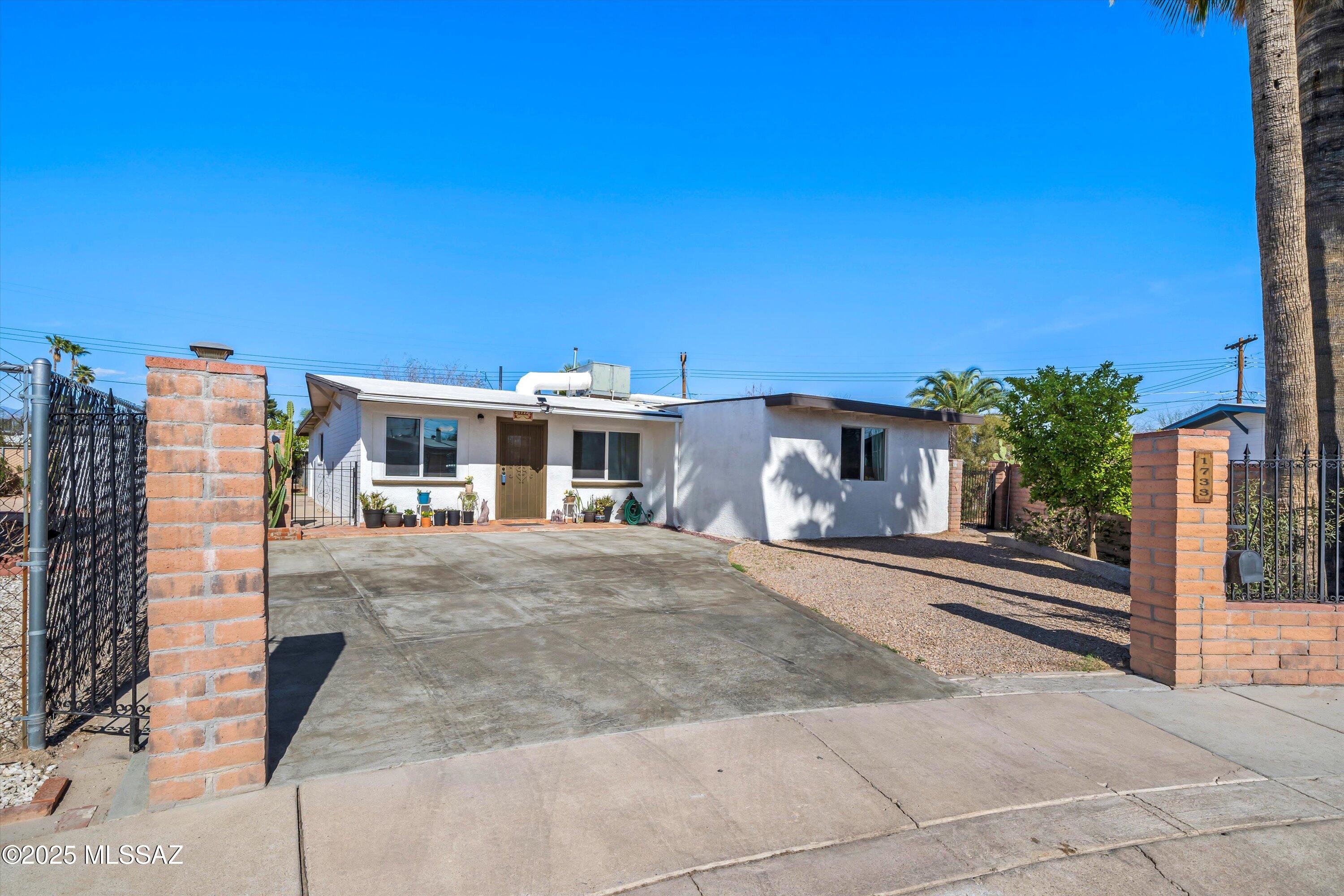 Charming Central Tucson Home with Fireplace & Updated Kitchen.  Discover the perfect blend of Southwest charm and modern comfort in this delightful 2-bedroom plus extra room, 1-bath home in the heart of Central Tucson. Featuring  Saltillo tile and built-ins, this home exudes warmth and character.  The cozy fireplace in the dining room/family room creates an inviting atmosphere, while the updated kitchen boasts modern finishes and appliances, making it both stylish and functional. A dedicated outdoor laundry space adds convenience.  Step outside to a  backyard filled with mature greenery, including two varieties of lemon trees and two fig trees—perfect for enjoying fresh fruit year-round.  Take advantage of collecting rain water with 2 rain barrels for easy watering.  Ideally located near Reid Park and Reid Park Zoo, this home offers easy access to downtown Tucson, the University of Arizona, shopping, dining, and entertainment.  Don't miss out on this Tucson gemschedule your showing today!