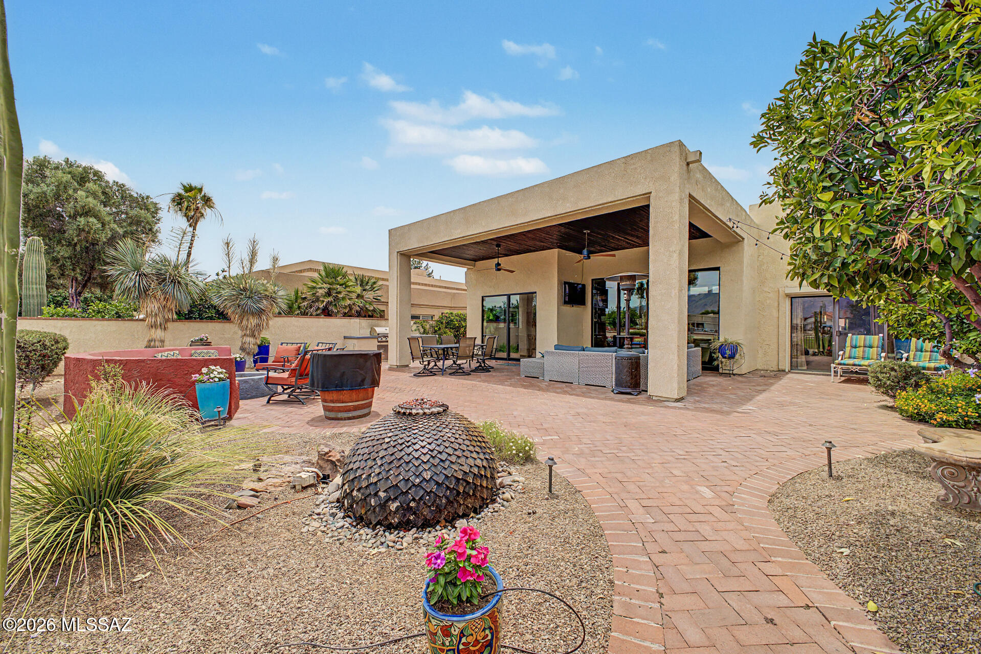 Impeccably updated, golf course home in Tucson National.  Located on the 5th Fairway of the Omni Sonoran Course, with incredible, unobstructed mountain views. 
This home has it all with amazing indoor and outdoor living.  Tall ceilings, 10 foot glass sliding doors, tons of light and a spacious floorplan.   The yard is low maintenance with multiple seating areas and a gas outdoor firepit.  
Enjoy a tastefully updated kitchen with superior cabinetry, quartz counters and  name brand stainless steel appliances. , ... a  chef's delight.   Updated bathrooms, flooring and upgraded interior finishes.  
2.5 car garage with plenty of  storage & space for your golf cart.  
This property is a must see.  You'll love this place!  Call for your appointment now.