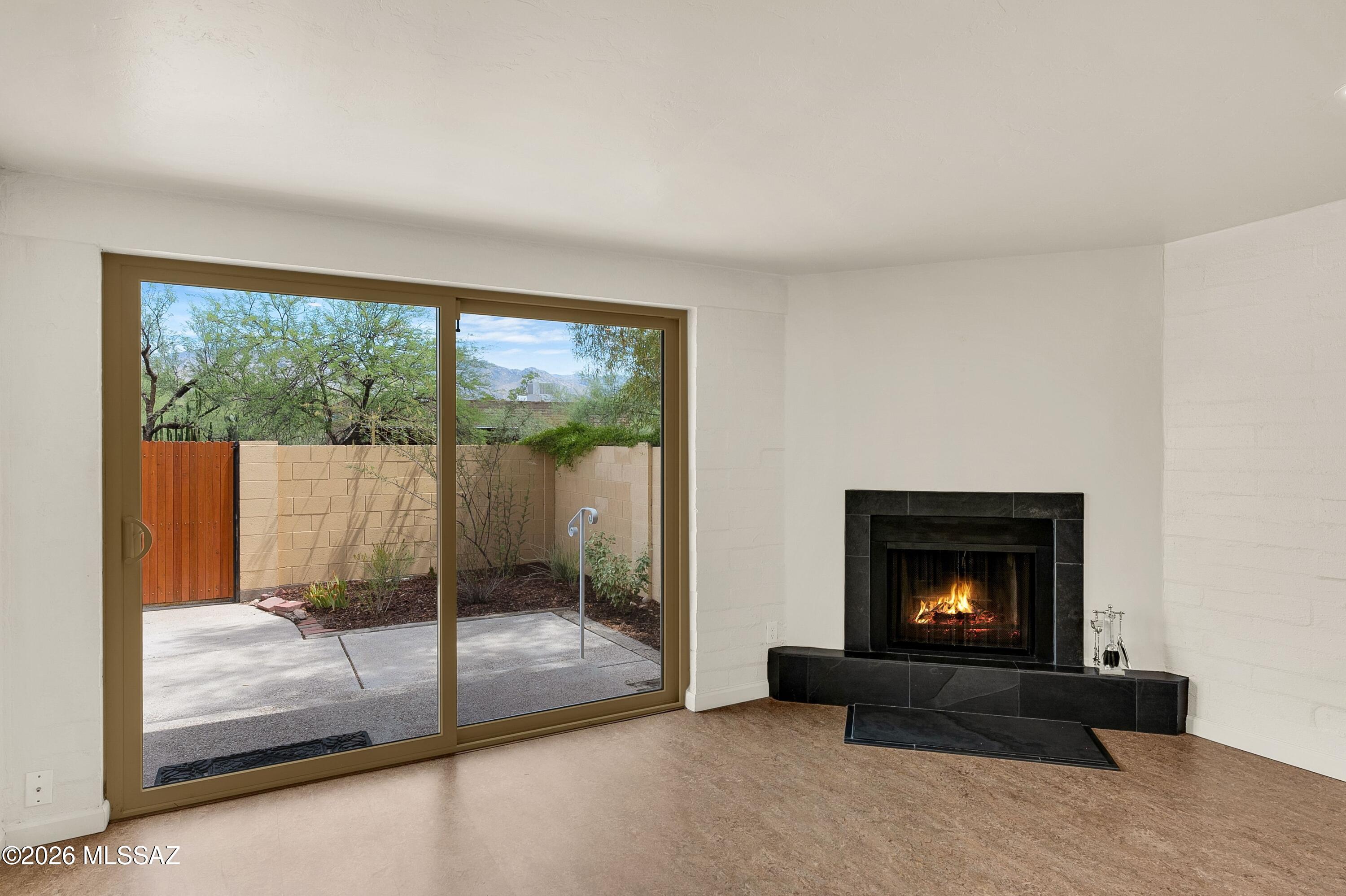 The very best mountain views & the best location in San Francisco Square, a sweet condominium complex found in the Old Ft. Lowell historic district. Meticulously maintained and thoughtfully upgraded. Abundant natural light. Great room with slate fireplace hearth and French Marie Therese chandelier opens to custom north-facing patio with irrigated desert landscape. Spotless kitchen, newer appliances, Corian countertops, soft-close drawers, hand-crafted shelving, breakfast bar. Marmoleum and tile floors throughout. W/D Convey. Plenty of storage. Water included in HOA. Peaceful, quiet courtyard filled with trees and shade. Conveniently located to Natural Grocers, TMC, Plaza Palomino. Option to join Old Ft Lowell Live at Home program. Charm, comfort and Tucson character.