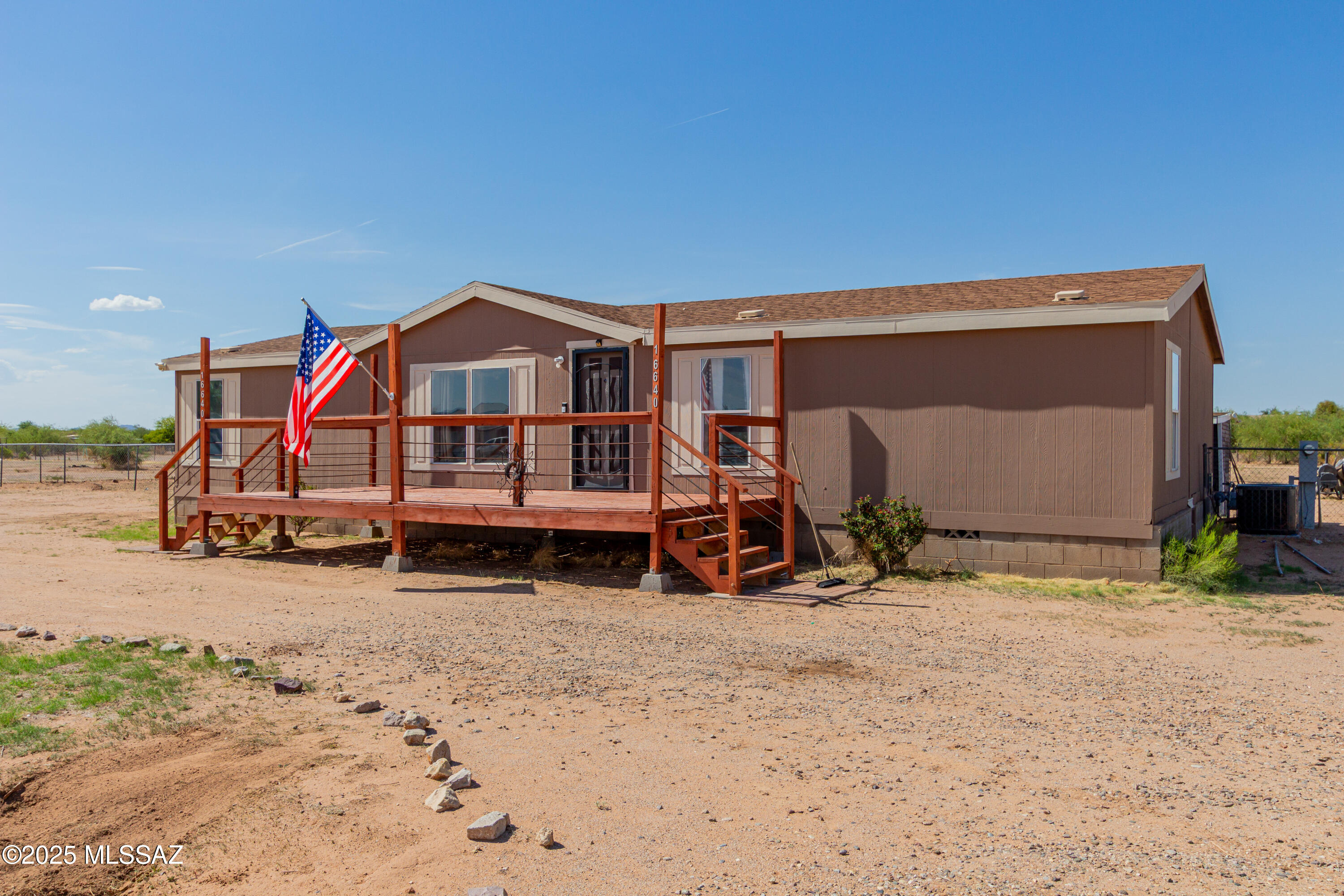 Your very own 1.15 acre lot with mature landscape and a quiet desert oasis. Step inside from the custom front deck into this 3 bedroom 2 bathroom home with a split floor plan. Laminate flooring and carpet throughout. Bright natural light that beams through the open kitchen and living spaces. Primary suite has a walk in closet, ceiling fan and large primary bath equipped with a garden tub, separate shower and great storage. Outside you will find two large sheds (one could be a workshop), fruit trees and a covered patio. Fully fenced backyard, with double gate access. Bring your toys, zoned for horses, and don't miss the vibrant stars at night!!!