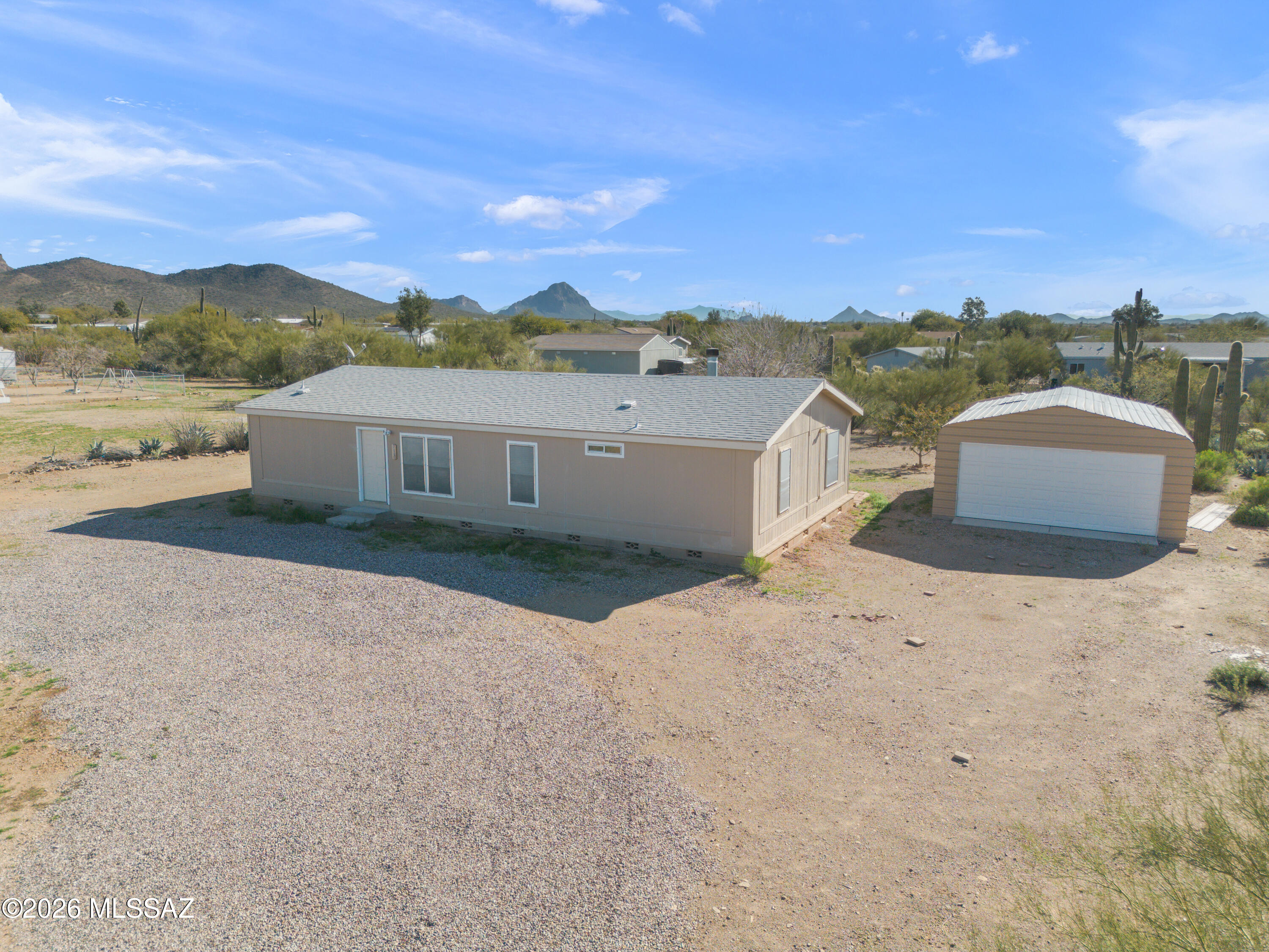 This gorgeously-updated home on 0.92 acres of horse property is waiting for you. Offering three bedrooms & two bathrooms in 1,568 sq.ft., there's plenty of space for you to spread-out. Enter the property from the circular gravel driveway with easy access to the detached two-car garage/workshop. Inside the home, you can enjoy two separate living areas (one with a wood-burning fireplace for chilly winter nights), a dedicated dinette, & a renovated kitchen with hickory cabinetry & appliances included. Both bathrooms have been luxuriously updated to include new tile surrounds & new modern vanities. Other improvements include water-proof luxury vinyl planks throughout, 6'' baseboards, 70-inch ceiling fans, modern LED lighting, newer HVAC system, & a WiFi thermostat for easy remote control. All of this offered with easy access to the Tucson Mountain range, endless hiking & biking trails, the Arizona Sonoran Desert Museum, Gates Pass, & other necessary conveniences like shopping & dining! This non-HOA neighborhood is the perfect blend of community & privacy. Come, see, stay - you won't regret it!