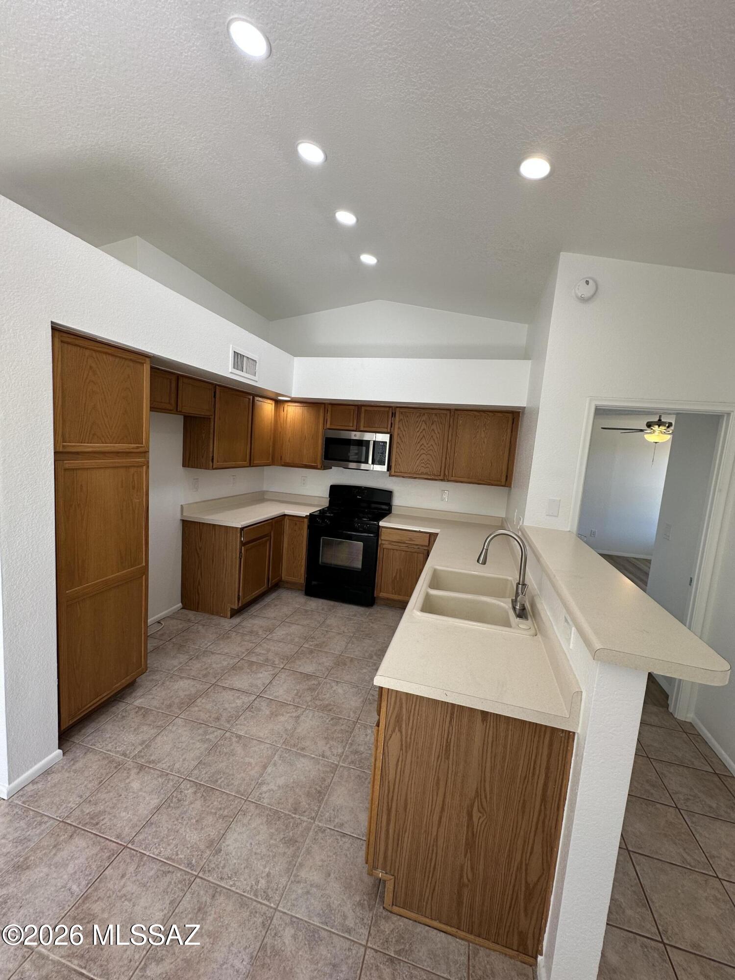 Welcome to this beautifully home located in the desirable Sunset Pointe community. Convenient NW locale nearby shopping/schools/parks/big box stores/golf/freeway access. COMMUNITY POOL/SPA. This bright/comfortable home has flexible living areas for formal/informal living needs.,Vaulted ceilings. Kitchen is central that opens to spacious bay dinette that can accommodate large dining needs plus gas range, new microwave, new faucets. Living areas on either side of kitchen/dinette one opens to rear yard thru sliders to covered patio the other has bay window. Split BR plan provides private MBR to the rear of the home w/walk-in closet & adjoining bath w/walk in shower & dual sinks.  New flooring in all 3 bedrooms. Freshly painted inside.
