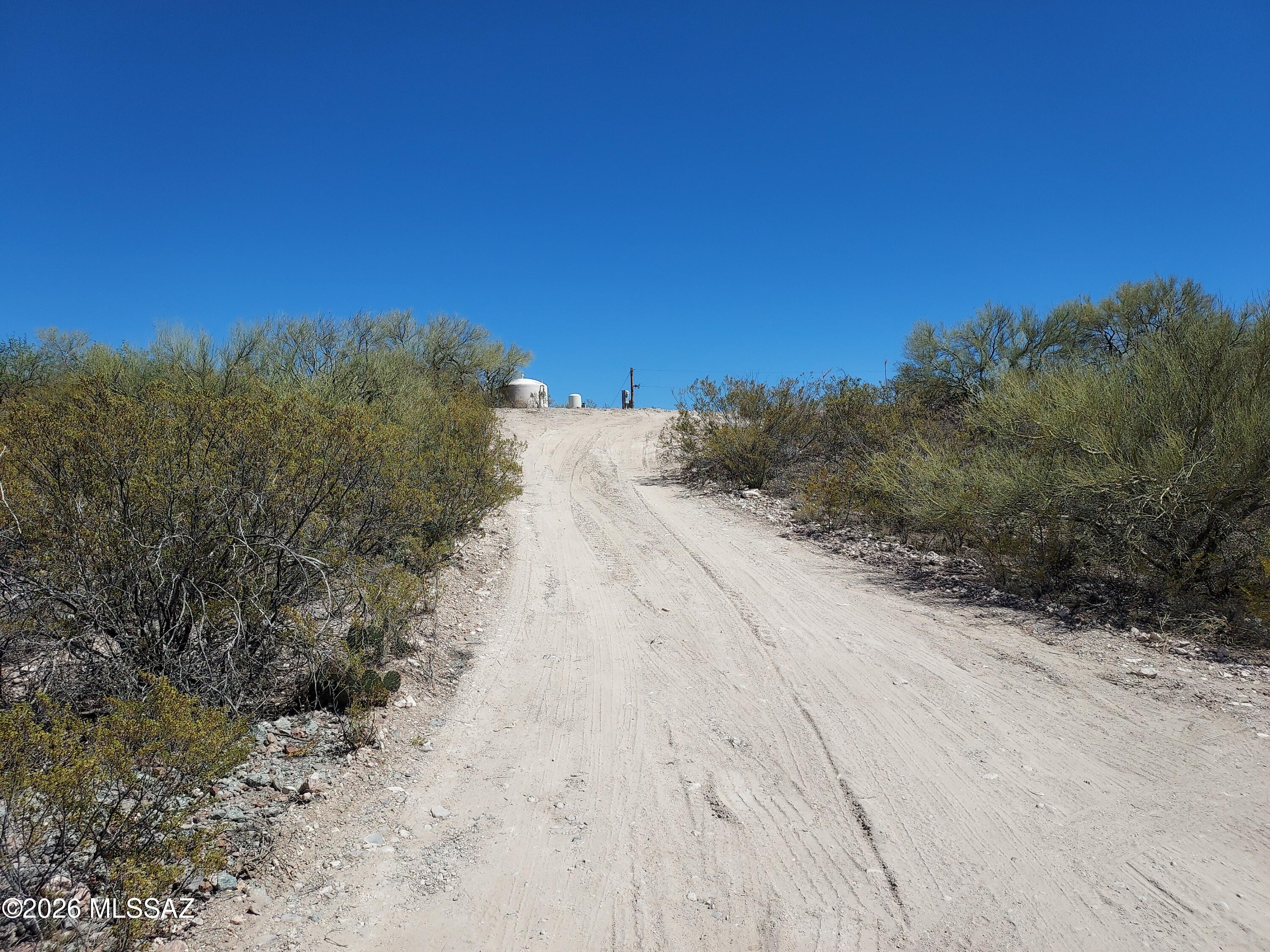 This is a 4.57 acre buildable lot with beautiful views to the south and west. A manufactured home sat here for many years, so the property is already set up nicely. There is a shared well, electricity on site, and telephone service available. There is also a prepared pad where a propane tank used to sit. The property is partially (3/4) fenced with a chain link fence, plus an opening for the driveway.