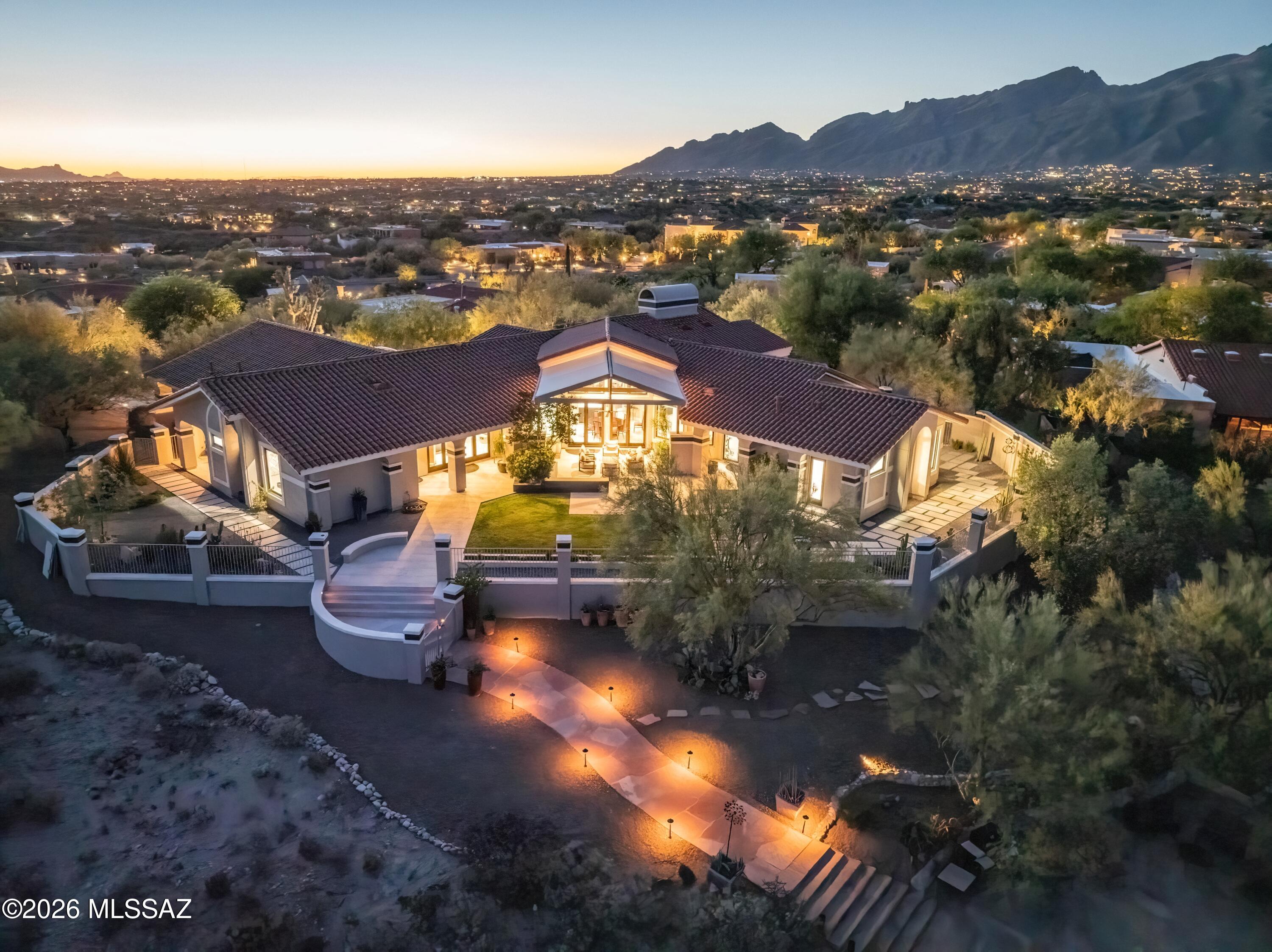 Beautiful meticulous custom home premium lot! Unmatched attention to detail, every room oriented to take in views. Private foothills resort style living .  TMC is 5 miles, UofA 10 miles & TIA 16 miles from home.  3533 sq ft of luxury w/ split floor plan.  Kitchen located in  heart of the home splits the den, 2 guest bedrooms with a Jack and Jill bathroom & 1/2 bath from the living, dining room, office/bedroom and primary suite.  2 fireplaces.  Kitchen has 2 tone cabinets, eat in bar, quartz/granite, Viking chef's SS kitchen & gorgeous butlers pantry. East sunrise mountain views from  contemporary, louvered pergola, shaded & tiled back patio. Catalina Mountain views from the living room. 3 car garage w/ storage. 2019 roof & windows. Custom entry door. Pristine landscaping & mature cacti