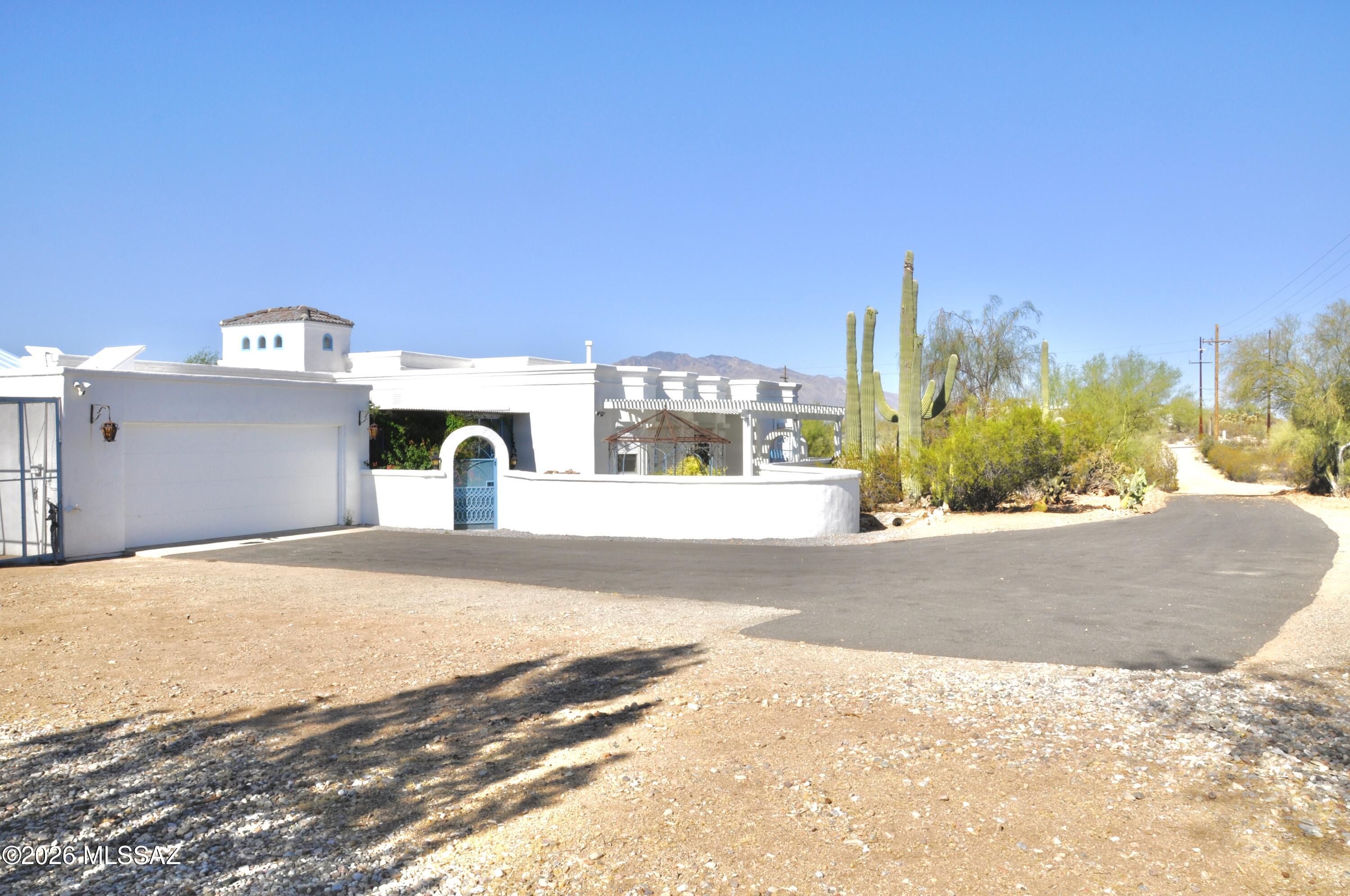 Custom built family home with bay windows, angular configurations, skylights , plenty storage throughout, built in bookcases in office. Perfect home for gathering/entertainment. Located in Tucson mountains on a hill top with panoramic views of sunrise/sunset, mountains and city. 3.03 acre lot with a large enclosed backyard to keep out desert critters, which includes an extended patio (length of the house),gated pool, plants and trees(lemon, grapefruit, pomegranate, fig). Enclosed area at front door with retractable awning and shade system covering. Large shop attached to west side of house, 3 pergolas with non-rust material(1 frontyard/2 backyard),2 rain catchers(NW and SE side of house), Percola water filter under kitchen sink and 2019 HVAC. Nearby trails for walking, biking & horses.