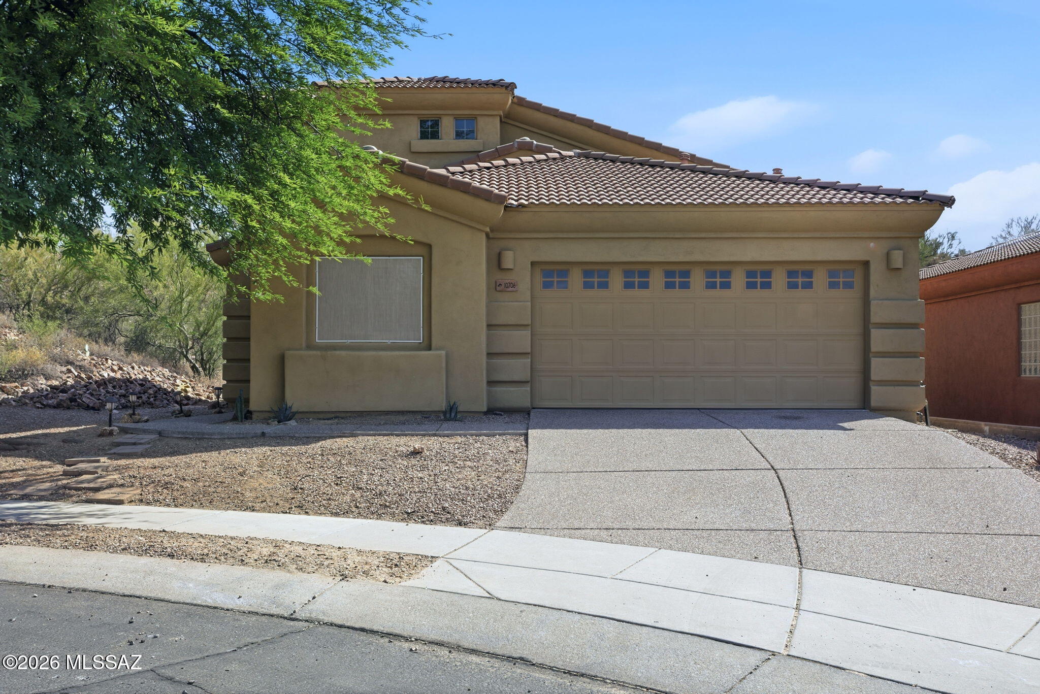 Spacious 5-bedroom, 3-bath home with stunning Catalina Mountain views and a thoughtfully designed layout. The open-concept main level features vaulted ceilings in the great room, creating a bright, airy atmosphere with an inviting sense of space. A highly desirable floor plan places the primary suite on the first floor, along with an additional bedroom, a versatile den or office that can also serve as a bedroom, a laundry room, and a full guest bath. Upstairs, you'll find two additional guest bedrooms and a generous private loft, offering a comfortable retreat for family or visitors. The well-appointed kitchen is ideal for everyday living and entertaining, with abundant cabinetry, granite countertops, a center island with bar seating, and a double oven. Conveniently located in Oro Valley,