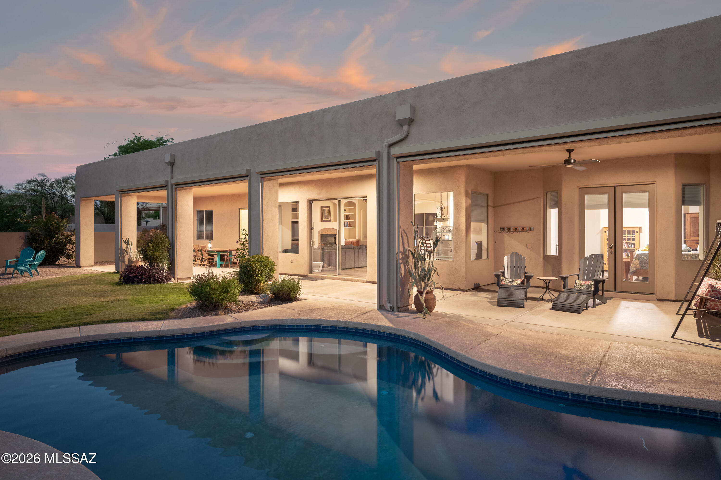 Southwestern living in Oro Valley! This spacious 4bd, 3ba home with den/office & 3-car garage offers a thoughtful floor plan with formal living & dining areas, a warm family room with fireplace, and a kitchen designed for gathering w/ generous cabinetry, granite counters, gas cooktop, & casual dining overlooking the resort-like backyard. Welcoming & private courtyard entry surrounded by mature landscaping. Backyard features a covered,  full-length patio, pool/spa, natural grass, & lush plantings with plenty of room to entertain. Primary suite includes a beautifully updated bath w/ dual vanities, walk-in rain shower & private pool access. Within walking distance to Vistoso Trails Preserve with over 6 miles of walking paths - see map in photos.