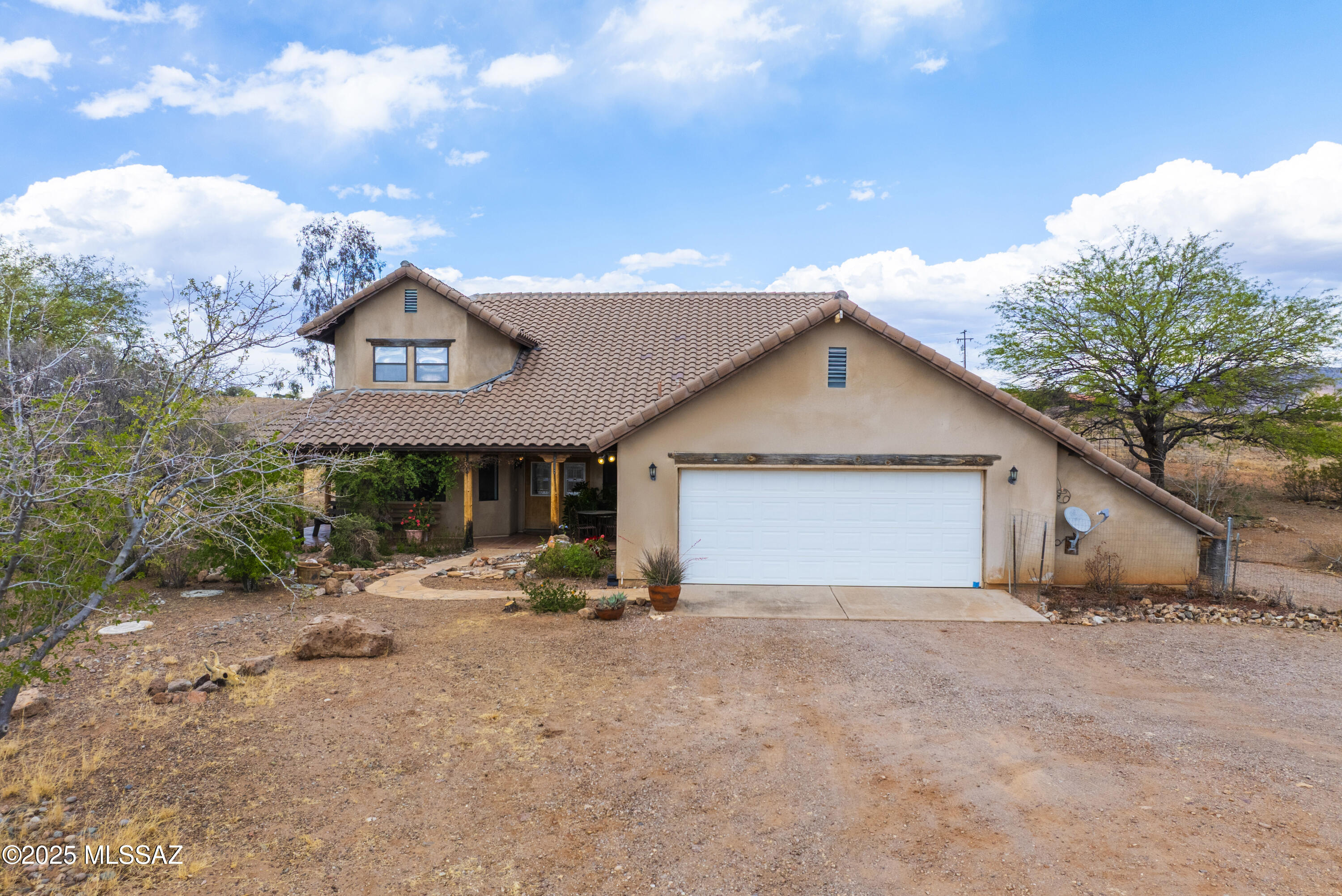 A really nice, classy custom built home in the very desirable Lake Patagonia Ranch Estates!!
This spacious, immaculate, two story, 2311 sq. ft. home boasts the most gorgeous views of the surrounding valleys and mountains.  Has a private well (water tastes delicious), covered patio that surrounds the house, mature landscaping, fireplace, office room, spiral staircase, greenhouse, and outdoor spa and shower.  This beautiful home is only minutes away from Lake Patagonia where you can enjoy swimming, boating and fishing !  This home sits on over 4 acres (OK to have horses)...with plenty of privacy , sunrises and sunsets...a a driveway loaded with ocotillos !!