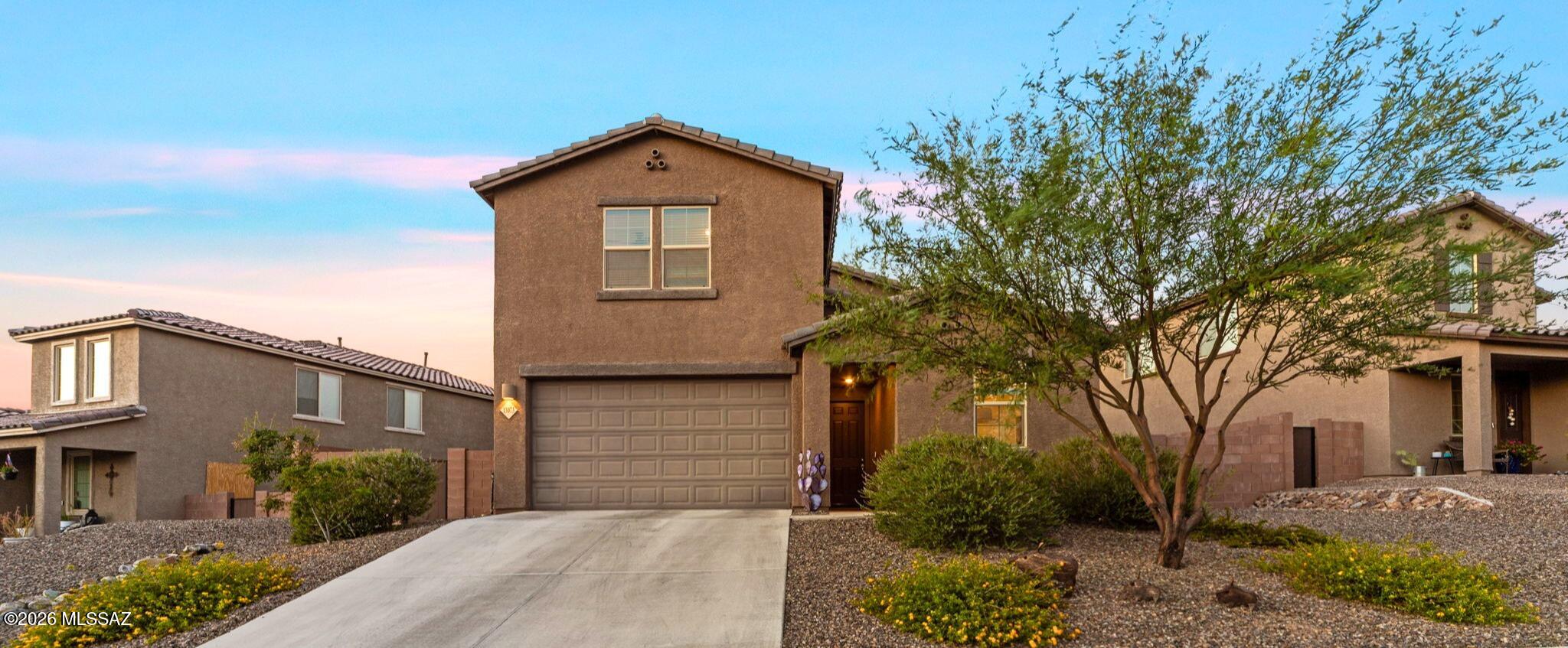 Located in the highly desirable Rocking K master-planned community and within the award-winning Vail School District, this newer 4-bedroom, 3-bath home is nestled in a private gated neighborhood and offers modern luxury, spacious living, and breathtaking mountain views. The open-concept floor plan features a large great room and chef's kitchen with granite countertops, double wall ovens, stainless steel appliances, abundant cabinetry, and a walk-in pantry. The main-level primary suite includes dual vanities, a walk-in shower, and generous closet space. Upstairs offers a versatile loft and additional living area. Complete with a 3-car tandem garage, epoxy floors, granite throughout, ample storage, and a spacious backyard, this home is the perfect blend of comfort and style.