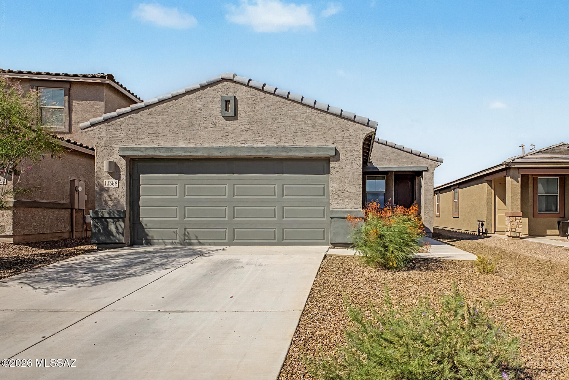 Welcome to an almost new 2024 built home in the highly sought after Gladden Farms master-planned community. With no neighbors directly in front or behind, this home offers privacy and  gorgeous mountain views. The open concept layout and modern finishes, with natural light make this home feel bright and welcoming Since it was built in 2024, everything still feels new, from the flooring to the fixtures. You get all the benefits of new construction without the wait and a finished backyard. Gladden Farms is one of Marana's premier communities, offering over 850 acres of green space, 30+ themed parks and playgrounds, a splash pad, dog parks, sports fields, basketball courts, and miles of walking paths, all just steps from your front door. Gladden Farms Elementary and the brand-new Tangerine Farms K-8 school are both within walking distance. You're minutes from Fry's Marketplace, Downtown Marana's growing dining and  retail scene, the MARC community center, and the Tucson Premium Outlets. Commuting is easy with I-10 just around the corner, putting downtown Tucson about 20 minutes away. This is the move-in-ready Gladden Farms gem you've been waiting for. Come see it before it's gone!