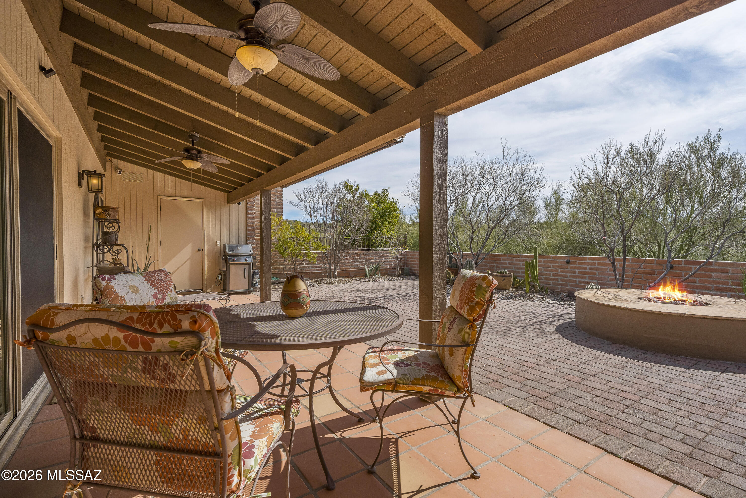 MUST SEE! Beautifully maintained 2BD/2BA burnt adobe townhome in Sunrise Territory Village, in the Fairfield Community of the Catalina Foothills. Spacious and well-designed 1,486 sq ft floor plan featuring classic Saltillo tile throughout, an updated kitchen and baths with shaker cabinetry, upgraded stainless steel appliances, and granite/quartz surfaces.

Additional features include custom plantation shutters, new double pained windows, solid wood interior doors, a clean double-car garage with epoxy flooring, and established desert landscaping. Outdoor enjoyment includes a private gas fire pit plus access to the community pool and spa.

Peace of mind comes with HVAC system,  roof and water heater regularly serviced and maintained. This turn-key property offers rare access to a highly coveted Foothills community with limited turnover and is close to nearby amenities, shopping, dining, and outdoor activities including hiking, biking, and golf.
