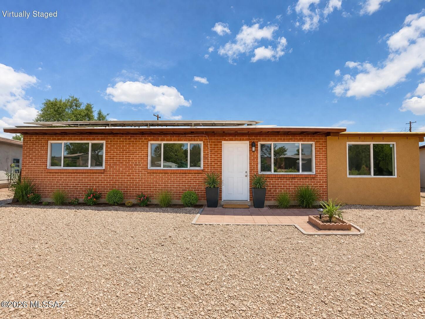 Move-in ready and thoughtfully updated, this solid red brick home sits on a large lot and offers 5 bedrooms, 2 beautifully renovated bathrooms, and plenty of space for comfortable living. The bright, remodeled kitchen features brand new cabinetry, quartz countertops, and ample storage. Tile flooring runs throughout, while the spacious living room is filled with natural light and showcases a cozy fireplace. Additional highlights include a versatile Arizona room, laundry room, ceiling fans throughout, and paid solar panels for added energy efficiency. Step outside to a private, block-walled backyard with plenty of space to relax, entertain, or enjoy outdoor living. Don't miss this beautifully updated home. Schedule your showing today!