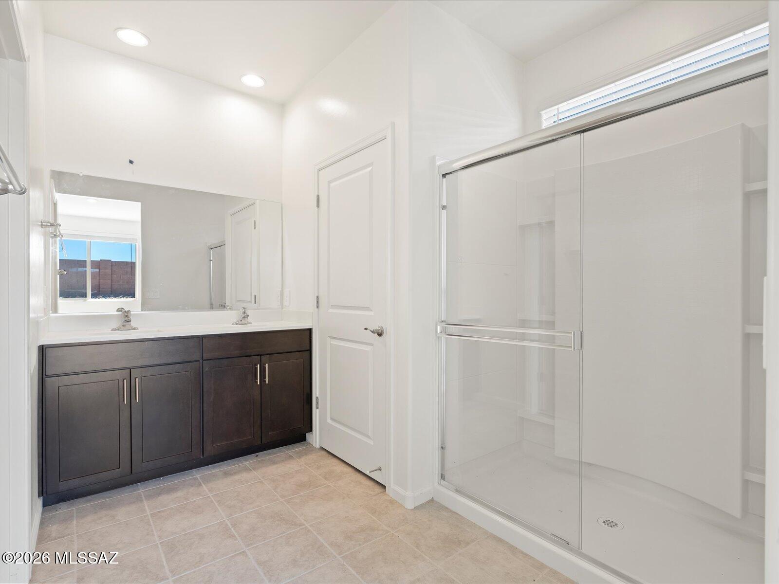 Enjoy your morning coffee on the peaceful covered patio of this 3-bedroom, 2-bath home. The thoughtfully designed single-story layout features a spacious primary suite with dual sinks and a walk-in closet. The open-concept living area is perfect for entertaining and everyday living. Sunset Crest is now selling at Ajo & Kinney, offering a quiet desert setting with community amenities like a playground, picnic areas, and shaded ramadas. Built with modern, energy-efficient features, these homes are designed for comfort, wellness, and long-term savings.