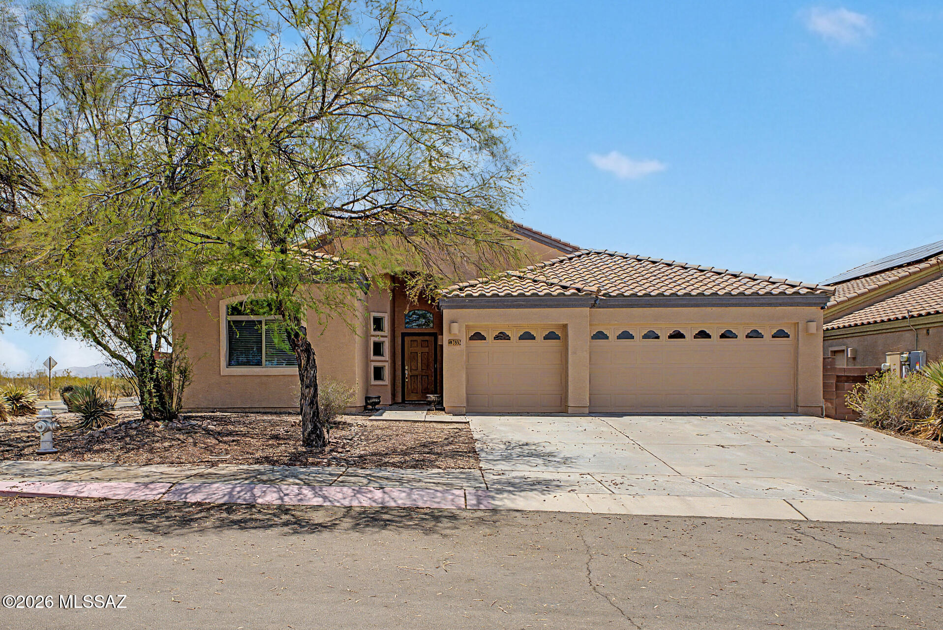 This adorable 4-bedroom, 2-bathroom residence is the one for you! Resting on a desirable corner lot, featuring great curb appeal and a 3-car garage. Inside, you'll discover bright and inviting living areas ready to welcome you and your loved ones, showcasing tile flooring, carpet in all the right places, arched passageways, and a soothing palette. The kitchen boasts ample cabinets with crown molding, granite countertops, SS appliances, and a two-tiered island. Enjoy a good night's rest in the primary suite, complete with a private bathroom with a separate shower & tub, a practical walk-in closet, and direct outdoor access for added convenience. The backyard provides plenty of space for outdoor fun, including a covered patio and a seating space with flagstone flooring. Truly a must-see!