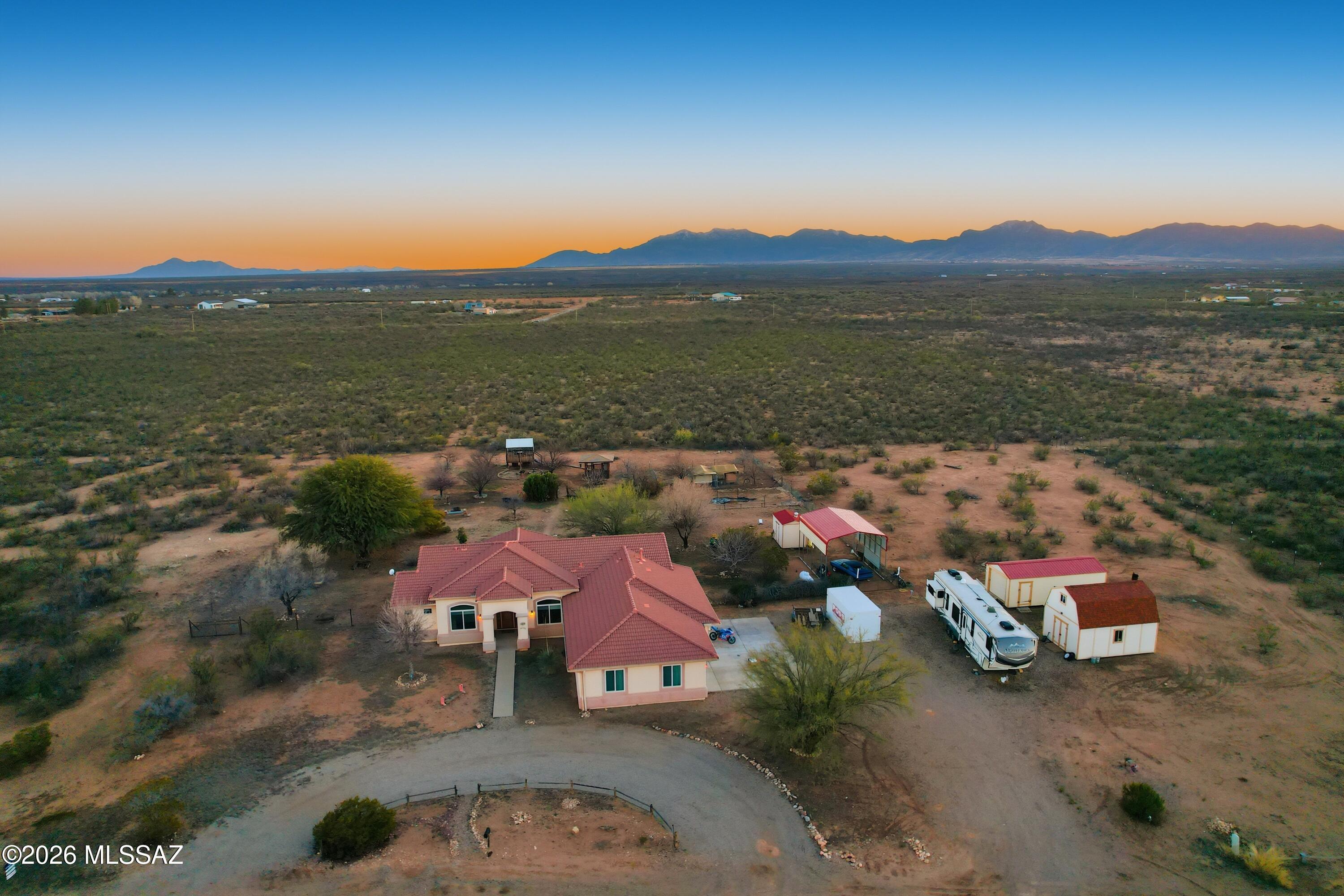 INVESTOR SPECIAL. BIG PRICE REDUCTION. 4 ACRES • MOUNTAIN VIEWS • NO HOA • ROOM FOR ALL THE TOYS Set on 4 usable acres with mountain views in every direction. Close to Fort Huachuca, Sierra Vista and the wineries of Elgin/Sonoita. 2300 sq. 3 bed/3 bath. Yard is fenced. Expansive 3 car garage with RV parking and room for all toys, boats, etc. Shared well has only 3 homes on it. Well is at edge of property, and on neighbors parcel. Orchard on property. tep outside and you've got your own mini-homestead:
* Orchard with fruit & nut trees
*Room to breathe, garden, roam, or simply enjoy the quiet
*NO HOA - bring your plans, your projects, your lifestyle
Need storage? You're covered.
*Oversized 3-car garage with room for ATVs, workshop space, and serious storage
*Covered parking with electricity for RV hookup
*Storage, storage, stor