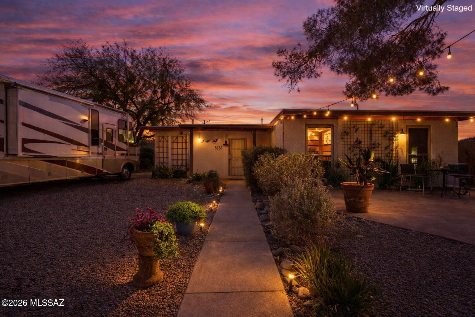 This charming 3 bed, 2 bath residence features a unique and stunning front yard oasis with beautiful mountain views, all nestled in the quiet and highly desired Glenn Aire neighborhood. Inside, enjoy an open living area with a soothing palette, dual-pane windows, and sleek concrete flooring with no carpet throughout. The eat-in kitchen offers ample wood cabinetry, recessed lighting, and stainless steel appliances. The primary bedroom includes a private bathroom and a spacious walk-in closet. Out back, you'll love the space for storage and projects with 2 large sheds, including a workshop/storage area with electric and insulation, plus Rain Bird irrigation throughout the yard. RV parking is a standout with an automatic gate, 30-amp hook-ups, and easy access. One block away from Fort Lowell Park and The Tucson Loop. Make it yours today!