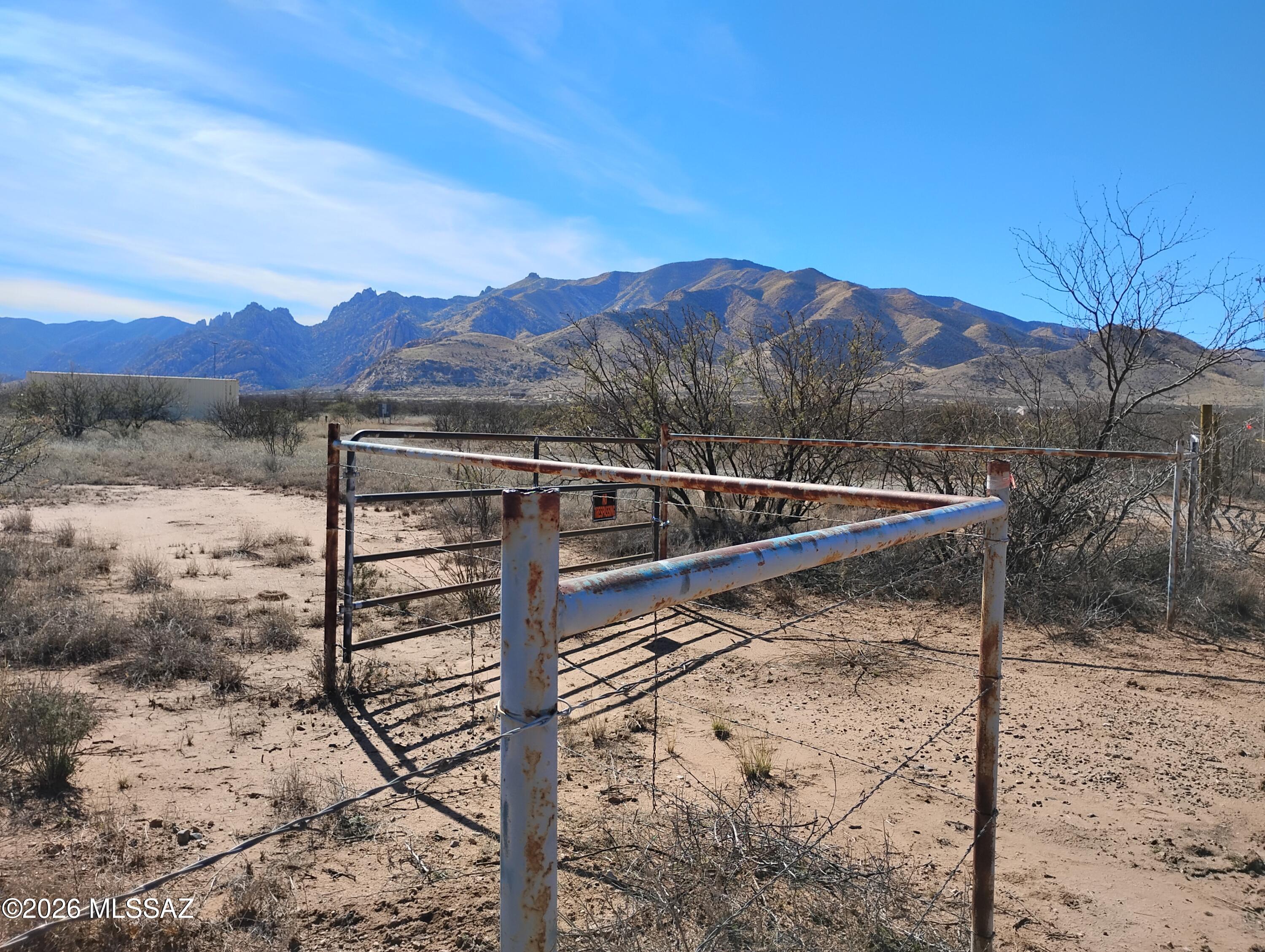 Electrical to county-maintained road. Fenced on north, south and east sides; the west side is open/shared with adjacent property owner. There is a shared well.