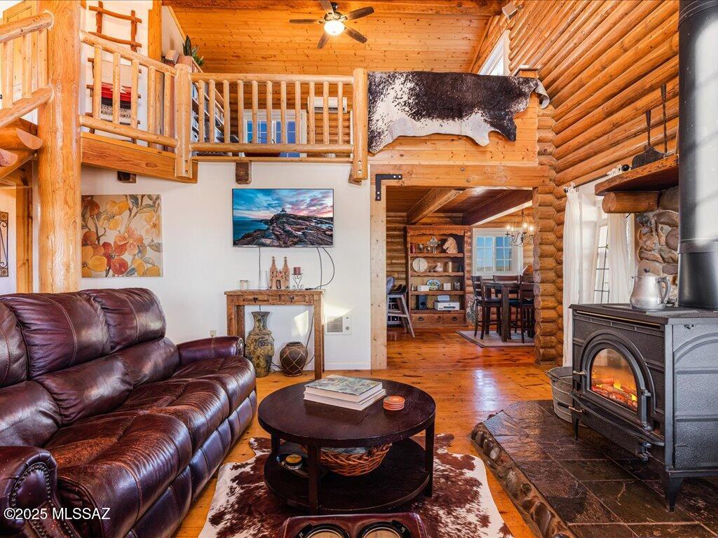 Beautiful Log Home in Elgin, gated & fully fenced, park like 10 acres with large mature trees, Hot tub & Swim spa, fenced garden, fruit trees, small vineyard, chicken coop, goat pen, mare motel & 2 large pastures. A Detached garage with owned solar panels, 2 carports & large dog kennel. Private Well with water storage tank. Home has real wood floors, wood burning stove in living room, granite counter tops in kitchen, gas range, farmhouse sink, stainless steel appliances, laundry room, large bedroom and bathroom downstairs, & a huge bedroom w/walk-in closet, bathroom w/dual sinks, shower & a large loft upstairs, room for 3rd bedroom! You can ride your horses to the local wineries, and an easy commute to Tucson, Neighbor has 5 acres next door can possibly be purchased