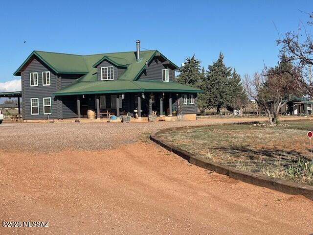 Beautiful Log Home in Elgin, gated & fully fenced, park like 10 acres with large mature trees, Hot tub & Swim spa, fenced garden, fruit trees, small vineyard, chicken coop, goat pen, mare motel & 2 large pastures. A Detached garage with owned solar panels, 2 carports & large dog kennel. Private Well with water storage tank. Home has real wood floors, wood burning stove in living room, granite counter tops in kitchen, gas range, farmhouse sink, stainless steel appliances, laundry room, large bedroom and bathroom downstairs, & a huge bedroom w/walk-in closet, bathroom w/dual sinks, shower & a large loft upstairs, room for 3rd bedroom! You can ride your horses to the local wineries, and an easy commute to Tucson, Neighbor has 5 acres next door can possibly be purchased