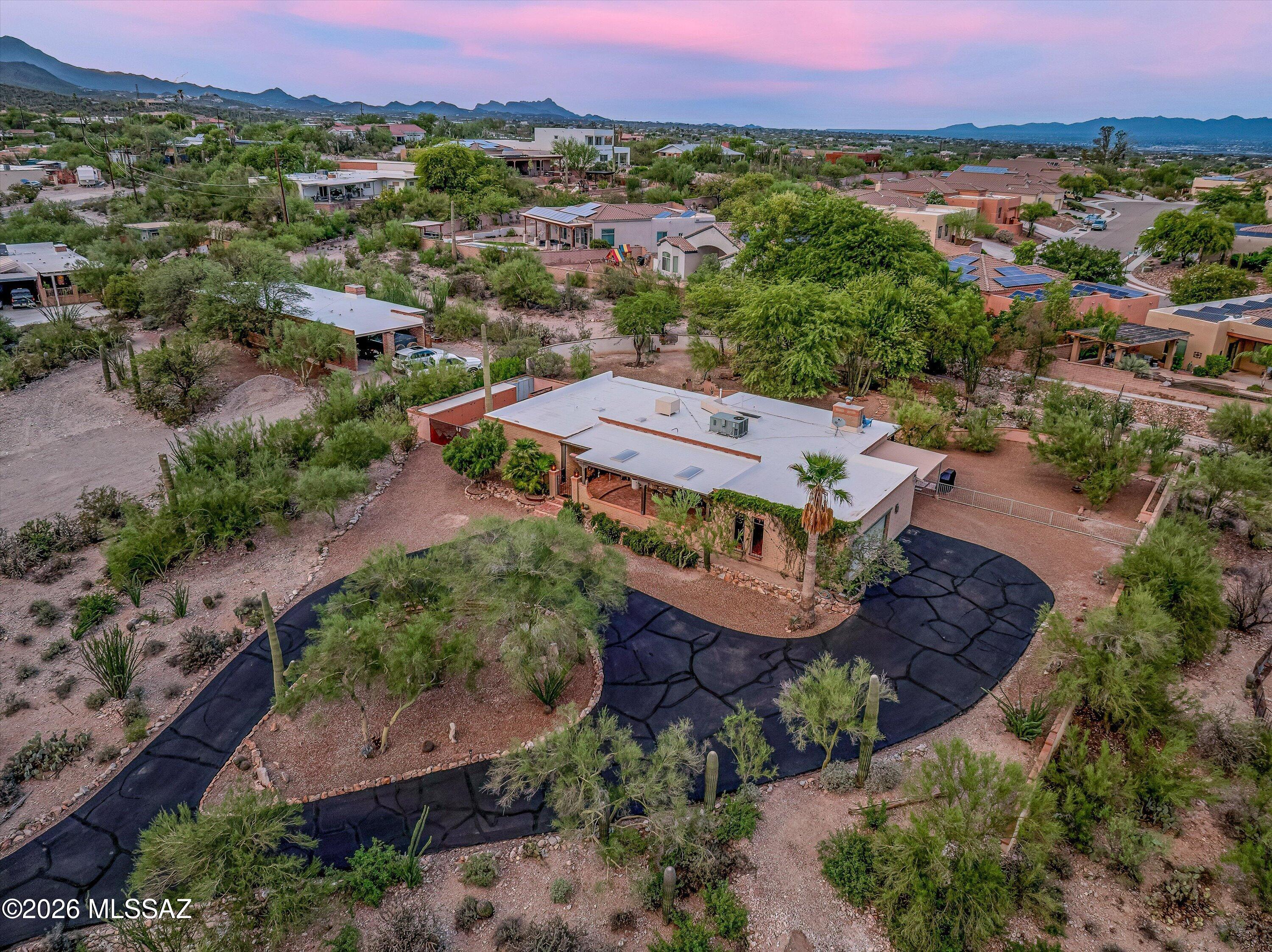 A Desert Dweller's Dream

Perched on a rolling hill on 1.06 acres of natural Sonoran Desert and nestled in one of Tucson's iconic West-side neighborhoods--known for its unique character, privacy, expansive views, and rugged desert beauty--this gorgeous 2,121 sq. ft. Territorial abode radiates warmth and comfort. Lovingly maintained and thoughtfully updated over the years, your new 3Bed, 2Bath home with a 2-car garage, additional carport, and gated RV parking packs all the charm that is expected from Tucson living.
A winding driveway, lush natural desert landscaping, and carefully stacked rock walls guide you home. A circular design creates the perfect setting for a center fountain and bench, inviting you to sit, unwind, and soak in the beauty of nature while enjoying views of the Tucson Mountains. An ample custom front porch beckons your presence and immediately sets the tone for the peaceful living experience that awaits. Whether enjoying your morning coffee, watching dramatic summer monsoon storms roll across the valley, or ending the day beneath Tucson's unforgettable sunsets, every moment celebrates the beauty of the Sonoran Desert.
Enter to stunning views of the Tucson Mountains framed by Andersen picture windows from both your Living/Dining rooms! Elegant tile floors and pristine engineered wood flooring elevate the space, while abundant natural light and an open, flexible floor plan provide ease of everyday living and effortless entertaining.
Enjoy a chef's kitchen complete with custom cabinetry, a grand center island, double sink, and a large skylight with an automated blind that allows you to adjust the natural lighting to your preference throughout the day. Perfectly positioned at the center of the home, the kitchen enjoys direct access to every living space, making it ideal for gathering with family and friends.
A comfortable family room becomes the natural gathering place on cool desert evenings as the brand-new gas fireplace (2025) emits warmth and creates a peaceful ambiance. From this vantage point, the majestic Catalina Mountains serve as a breathtaking natural backdrop, creating a view that changes beautifully throughout the day.
A grand primary ensuite offers the perfect place to unwind while enjoying subtle yet beautiful mountain views. Beautifully updated in 2018 and enhanced in 2026, the spa-like bathroom features a stunning glass shower, Delta fixtures, a large vanity with dual mirrors and updated vanity lighting, and an elegant tile surround. Two spacious closets, a linen closet, and enough room for a cozy reading nook make this personal retreat as functional as it is relaxing.
Two additional bedrooms enjoy views of your magnificent backyard and are both spacious, bright, and welcoming. The hall bathroom offers all the tasteful updates found in the primary bath, plus a freshly resurfaced tub, creating a cohesive feel throughout the home.
Immerse yourself in nature as you spend countless hours enjoying cool desert breezes from your backyard oasis. An extensive covered patio, fully fenced backyard, thoughtfully designed landscaping, and an elevated viewing spot come together to create an unforgettable outdoor experience. Whether gathering with family and friends, relaxing with a good book, or firing up the grill, every space was designed to embrace the surrounding desert and sweeping valley views. Even your grilling area enjoys a front-row seat to the spectacular scenery.
Need more space for vehicles? The additional carport provides exactly that. Looking for room for an RV, trailers, work equipment, or recreational toys? With no HOA, you're free to bring them all. A double gate leads to a dedicated RV parking area along the side of the home, while built-in storage cabinets help keep tools, materials, and equipment organized and protected.
Thoughtful improvements throughout the home provide beauty, functionality, and peace of mind. A new electrical panel (2025) offers confidence for years to come, while the new gas fireplace (2025) adds warmth and efficiency. Andersen picture windows beautifully frame the surrounding landscape while enhancing energy efficiency, and the engineered wood flooring brings timeless character to the living spaces. Beautifully updated kitchen and bathrooms, including the refreshed guest bath with its resurfaced tub, reflect the care invested throughout the home. (See the complete Updates List for additional improvements.)
This is not your typical two-car garage. Fresh polyaspartic floor coating elevates the space while the generous size allows for comfortable parking of two vehicles with room to spare. A 13.1' x 8' workshop area provides the perfect space for hobbies, projects, or additional storage. The laundry room offers convenient access to both the garage and family room, making everyday tasks--from unloading groceries to tackling laundry--effortless.
This distinctive home truly offers the best of everything: no HOA, an open floor plan, thoughtful updates, breathtaking mountain and valley views, expansive outdoor living areas, an additional carport, gated RV parking, and an undeniably spectacular setting.
The location is equally exceptional. Be in Downtown Tucson in less than 10 minutes to enjoy its vibrant restaurants, entertainment, shopping, museums, theaters, and the Mercado District. Just minutes away, Gates Pass offers one of Arizona's most scenic drives, leading you to Old Tucson, the Arizona-Sonora Desert Museum, and Tucson Mountain Park West.
Outdoor enthusiasts will appreciate immediate access to some of Tucson's finest trail systems, including Painted Hills, Sweetwater Preserve, Camino de Oeste, Gates Pass, and the Dave Yetman Trail. Whether your passion is hiking, trail running, mountain biking, road cycling, birdwatching, or simply enjoying an evening walk along Anklam Road or Camino de Oeste, this West-side location places you at the heart of it all.
The West Side of Tucson is treasured for its authentic Sonoran Desert landscape, protected open spaces, towering saguaros, abundant wildlife, spectacular sunsets, and the peaceful feeling of living surrounded by nature while remaining remarkably close to city conveniences. It is a lifestyle that few areas of Tucson can truly offer.
Convenient access to I-10, the University of Arizona, major hospitals, Tucson International Airport, Davis-Monthan Air Force Base, Caterpillar, Raytheon, grocery stores,Hospital,  dining, and everyday amenities means you're never far from where you need to be.
Take the time to stop and admire the ever-changing beauty of the Sonoran Desert. Watch monsoon storms roll across the valley, enjoy the golden glow of sunset over the Tucson Mountains, and experience the quiet magic that makes this part of Tucson so special.
This is a home you truly must experience in person.