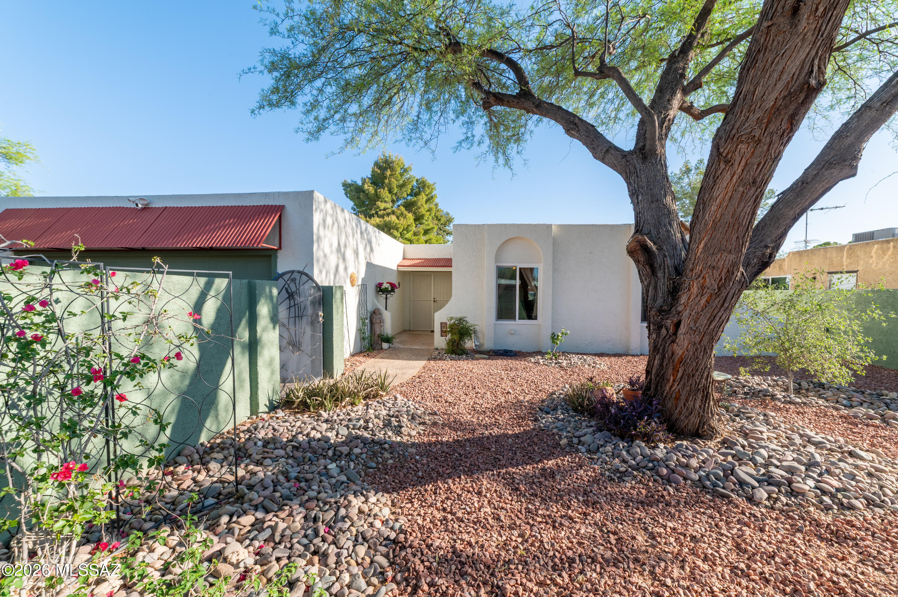 Welcome to this much-loved 3BR/2BA, 2-car garage home in Central Tucson, thoughtfully cared for and beautifully improved. A peaceful gated courtyard sets the tone, while the spacious backyard with mountain views, fruit trees and newly planted grass is ready for entertaining and Arizona sunsets. Inside, enjoy natural light, fresh paint, new carpet, ceiling fans in all bedrooms and updated hallway lighting. The remodeled kitchen shines with real birch custom soft-close cabinetry, granite counters, coffee bar, stainless appliances, new sink, hood, disposal, RO and faucets. Major improvements include new A/C in August 2025, roof recoat in 2024, new Andersen slider and screen, refreshed front rock and stabilized mesquite tree. Near shopping, dining, TMC, DM, and much more!
