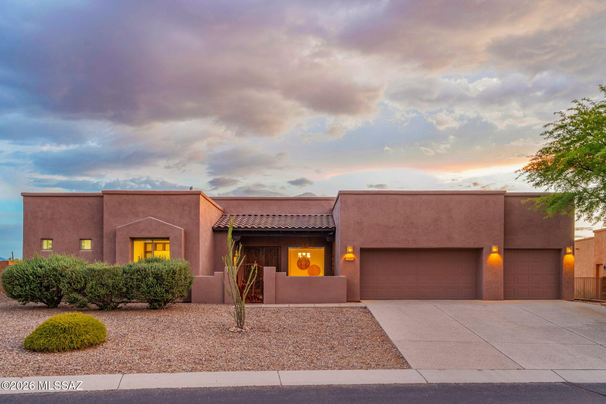 Quality craftsmanship and thoughtful design define this Pepper Viner-built home, ideally situated on a spacious, private lot in the gated community of Sycamore Canyon. The split-bedroom floor plan offers privacy and functionality, with a spacious primary suite featuring backyard access, dual vanities, a dedicated makeup area, soaking tub, walk-in shower, and a custom walk-in closet.

Designed for everyday living and entertaining, the open-concept great room is filled with natural light, highlighted by soaring ceilings and a wall of sliding glass doors that open to the backyard. The kitchen features warm cabinetry with pull-out shelving, stainless steel appliances, an electric  cooktop, wall oven, pantry, oversized island with seating and outlets, and direct access to the covered patio. Step outside to a private backyard backing to open desert, complete with a built-in gas grill, mountain views, and spectacular Arizona sunsets. Additional features include a charming front courtyard with French entry doors, an extended-length, extra-tall 3-car garage with backyard access. Newer wood-look ceramic tile flooring in the bedrooms. It is located within the award-winning Vail School District and offers access to the community pool and park. This move-in-ready home offers the perfect blend of comfort, quality, and Arizona living. Buyer to verify all facts + figures, including those in MLS.