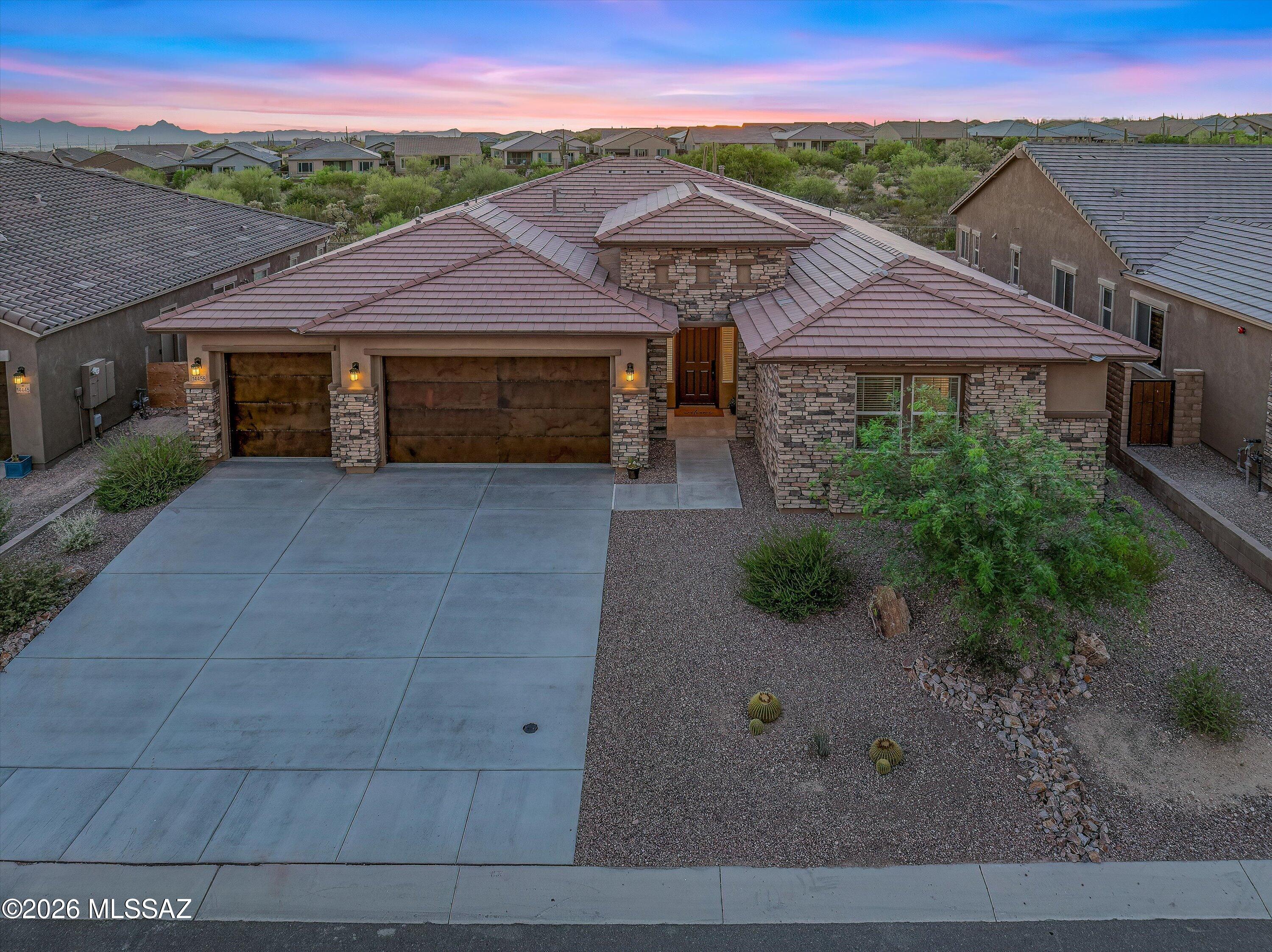 Experience luxury living without the wait! Welcome to this exceptional brand new 2025 construction home in the prestigious gated community of Saguaro Reserve, where designer finishes, premium upgrades, and breathtaking mountain views come together in one stunning package.


Offering 4 bedrooms, 3 full bathrooms, and a spacious 3-car garage, this thoughtfully designed home features 12-foot ceilings and an impressive 16-foot multi-slide glass door that fills the home with natural light and seamlessly connects indoor and outdoor living.


The gourmet chef's kitchen is the heart of the home, showcasing premium Café appliances, a generous Butler's pantry, two built-in wine refrigerators, quartz countertops, abundant cabinetry, and an oversized island perfect for entertaining. Unlike waiting months for new construction, this home is truly move-in ready. The professionally designed upgrades have already been completed, including custom designer paint throughout and a beautifully finished backyard featuring professional landscaping, pavers, and a putting green. Everything is ready for you to enjoy from day one.

The private backyard offers no neighbors directly behind, creating a peaceful setting to relax while taking in the beautiful mountain views and Arizona sunsets.

Additional features include a tankless water heater, energy-efficient construction, and all the benefits of owning a brand-new home with none of the hassle of selecting upgrades or waiting for construction to be completed.

This is a rare opportunity to own a fully upgraded, move-in-ready luxury home in one of Tucson's most desirable gated communities in Dove Mountain. Experience the perfect blend of modern elegance, comfort, privacy, and convenience at Saguaro Reserve.