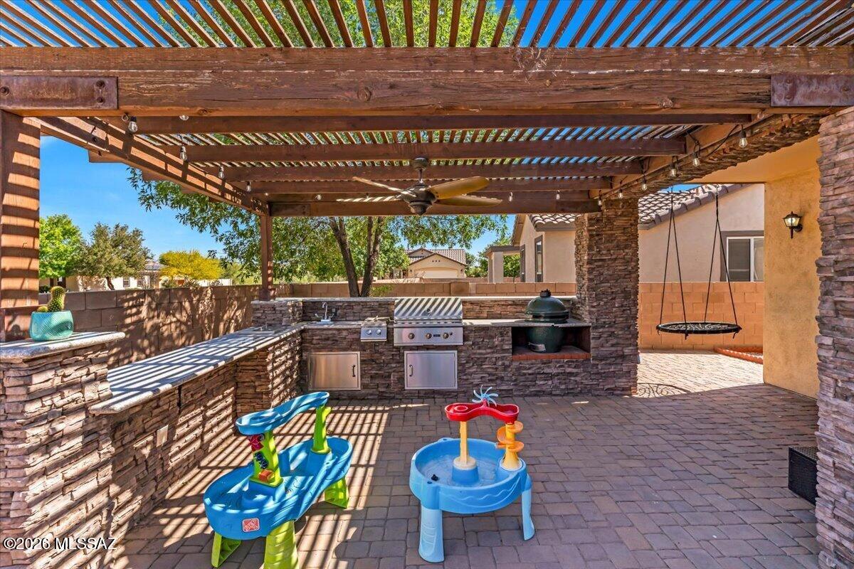 Assumable LOW RATE! 2.625%
Move-in ready home in Rancho Sahuarita with upgrades you won't find in most homes--plus no rear neighbors for added privacy. Inside, you'll find durable tile flooring throughout the entire home, along with a fully upgraded kitchen featuring a waterfall island countertop, farmhouse sink, wine fridge, and pull-out cabinetry for maximum storage.
The primary suite is a standout with a custom accent wall and TWO cedar-built walk-in closets--perfect for organizing uniforms, gear, and everyday wear. Out back, unwind or entertain with a built-in BBQ, outdoor kitchen, and fireplace in your private backyard space. Located in the master-planned Rancho Sahuarita community, you'll have access to pools, parks, fitness areas, and walking trails-- making it an easy transition for any military family looking for comfort, convenience, and community.