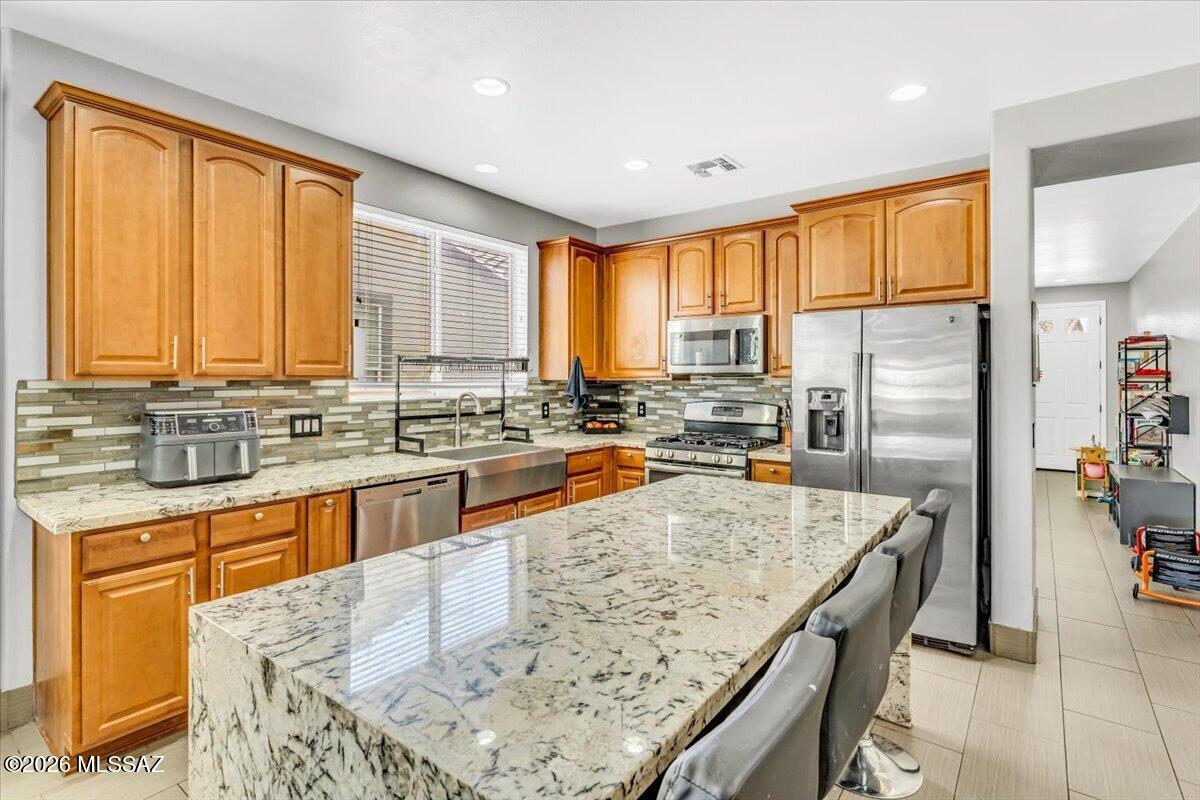 Assumable LOW RATE! 2.625%
Move-in ready home in Rancho Sahuarita with upgrades you won't find in most homes--plus no rear neighbors for added privacy. Inside, you'll find durable tile flooring throughout the entire home, along with a fully upgraded kitchen featuring a waterfall island countertop, farmhouse sink, wine fridge, and pull-out cabinetry for maximum storage.
The primary suite is a standout with a custom accent wall and TWO cedar-built walk-in closets--perfect for organizing uniforms, gear, and everyday wear. Out back, unwind or entertain with a built-in BBQ, outdoor kitchen, and fireplace in your private backyard space. Located in the master-planned Rancho Sahuarita community, you'll have access to pools, parks, fitness areas, and walking trails-- making it an easy transition for any military family looking for comfort, convenience, and community.