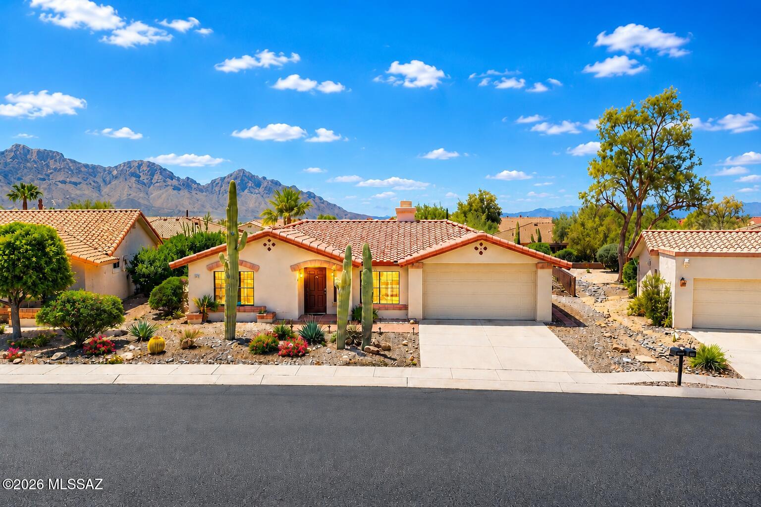 Enjoy the very best of Arizona living in this charming 1,035 sq. ft. Durango model home nestled in the heart of Sun City Oro Valley! This inviting home features a spacious living room with a cozy gas fireplace, a bright eat-in kitchen with breathtaking Catalina Mountain views, two comfortable bedrooms, including a serene owner's suite complete with an en-suite bath, walk-in shower and spectacular mountain views. Also, a bonus room with built in cabinetry. The two-car garage offers plenty of storage, while the beautifully landscaped backyard provides the perfect place to relax, entertain and soak in the stunning Catalina Mountains. Enjoy the Sun City lifestyle with an 18-hole golf course, pickleball, two pools, tennis, fitness center, artisan center, wood shop, clubs to join & so much more!