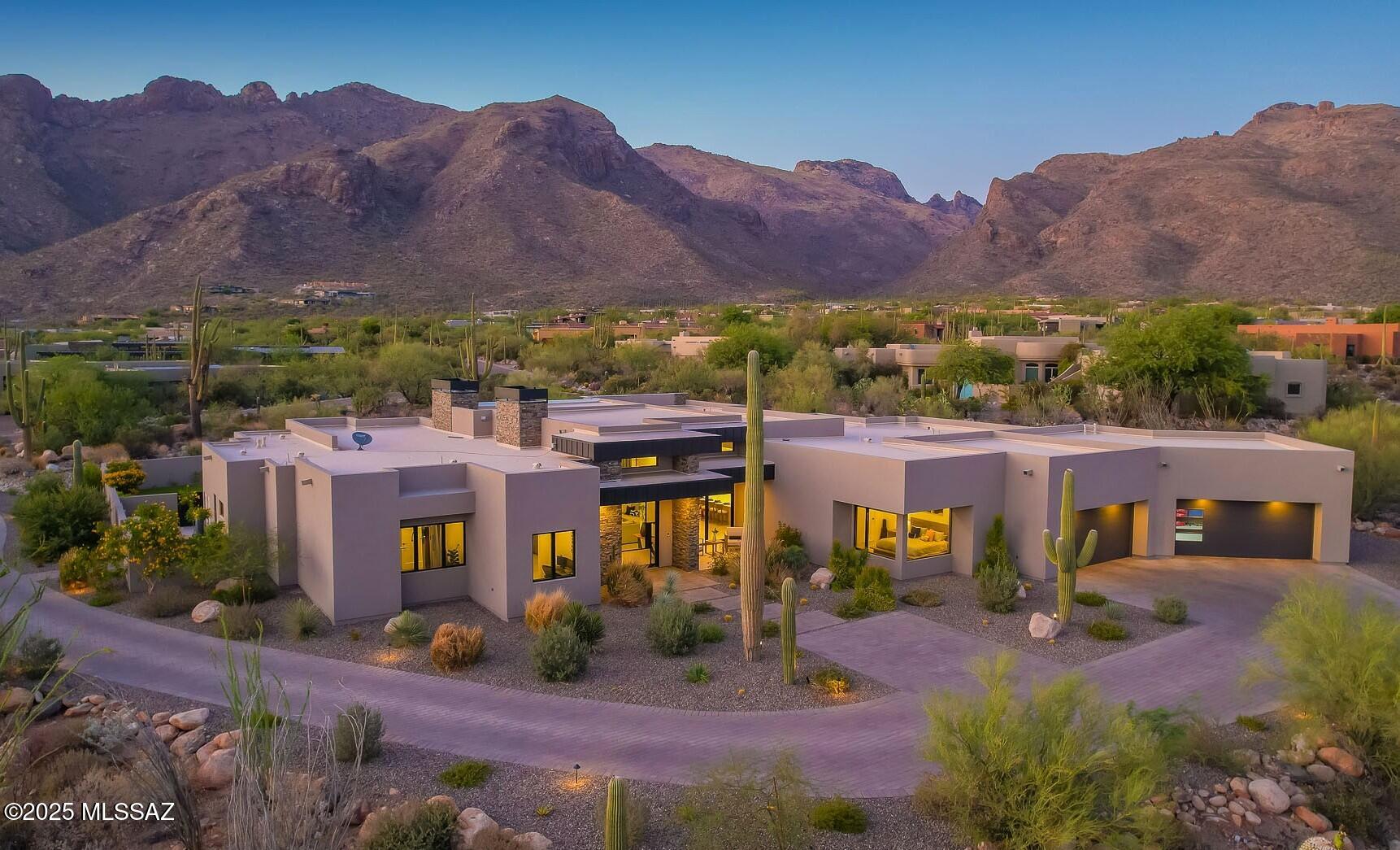 Welcome to the epitome of luxury living in the prestigious, double-gated Sunset Gardens enclave of Pima Canyon Estates. Designed by the renowned Simmons Design Group and completed in 2023, this striking modern residence offers 5189 square feet of masterfully crafted space with breathtaking north-facing views into majestic Pima Canyon. Step inside to find an open-concept layout with high-end finishes, soaring ceilings and brilliant window design providing elegant natural lighting. 4 Spacious, En-Suite Bedrooms plus a built-in office and fully equipped home gym, perfect for today's modern lifestyle. Outdoors, enjoy the generously sized Pebble Sheen pool and spa, massive north-facing rear patio and glorious desert sunsets. Auto enthusiasts will appreciate the over-sized 4-Car Garage.