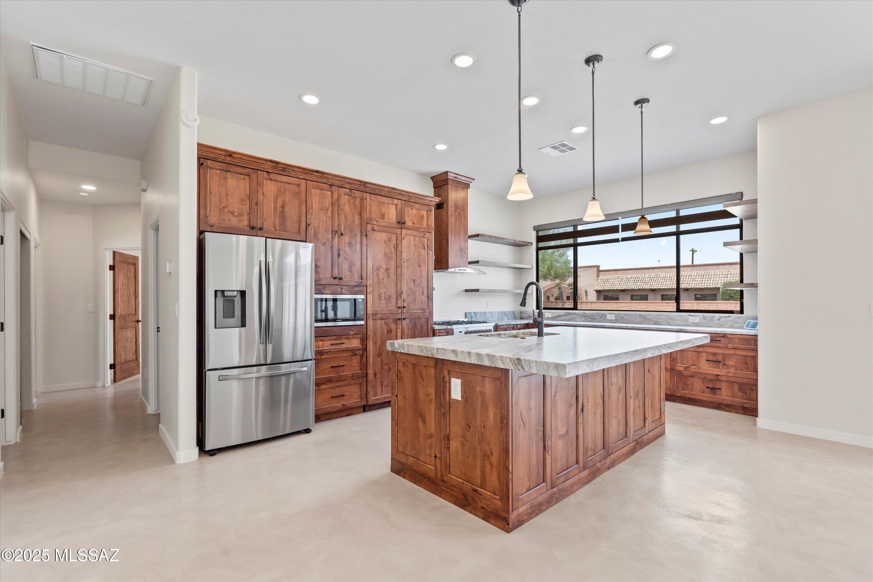 Amazing transformation! This property started life as a 3 bed, 2 bath 1309 sq.ft. house w/ 2 car carport. It was torn down to 1 wall and has been completely rebuilt. It is now a 3 bed, 3 1/2 bath, main house and a 1 bed, 1 bath guest house. 2500 sq.ft. home w/ a 3 car garage and guest house on .413 acre. You must see this property if you're looking for the spa living lifestyle. Featuring a cook's kitchen w/ large island w/ ''leathered'' slab granite, lots of custom-built Knotty Alder cabinets, gas stove w/ an artistic hood, stainless steel appliances and a window to the backyard. Don't miss the laundry room and walk-in storage behind pantry doors. Primary bedroom boasts huge walk-in closet, en-suite bath w/ walk-in shower, lrg. soaking tub, dual vanities, & linen closet. Fans in all rooms Each bedroom has its own private bath.  Wood-burning fireplace, for cozy winter nights. Enormous backyard, ready for a pool and spa or a kiddy wonderland! Could also use property as an investment property/ student rental. There is room to add two additional ADUs to the lot. Plenty of parking, large lot would allow necessary offsets.