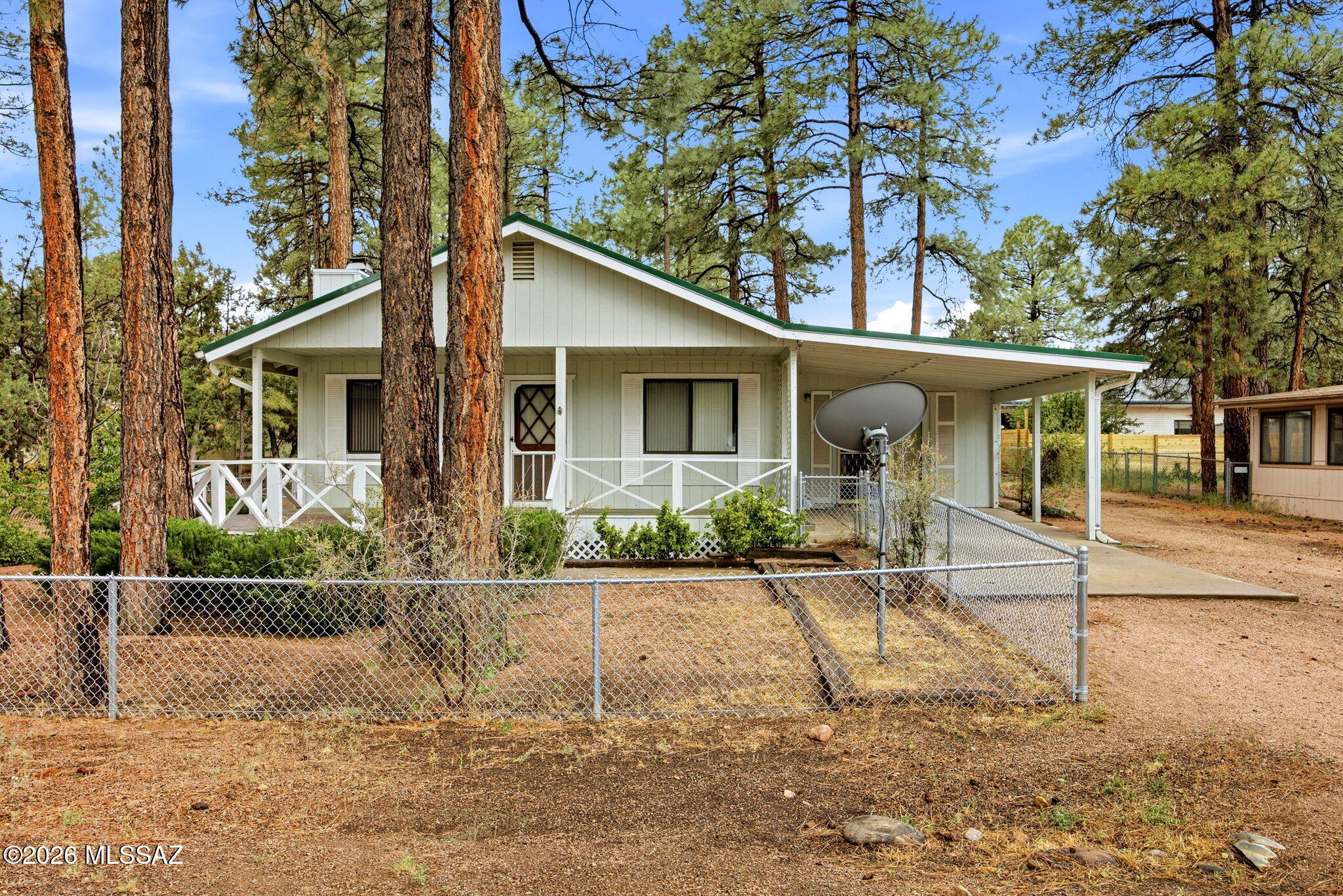 Enjoy this charming home or weekend getaway in the cool pines, just minutes from parks, shopping, and local amenities. The property features a large front deck, landscaped yard, and is fully fenced--perfect for pets. Inside, you'll find 3 bedrooms and 2 bathrooms, a spacious living room with a rock wood-burning fireplace, vaulted tongue-and-groove ceilings, and an additional family room that could serve as a game room or large office. The primary bedroom is generously sized with a walk-in closet, built-ins, and its own private deck. The primary bath includes a walk-in shower. Natural gas heating, and all appliances are included. Out back, there's a workshop/storage area, and the home sits on a quiet cul-de-sac, offering added privacy and a peaceful setting.
