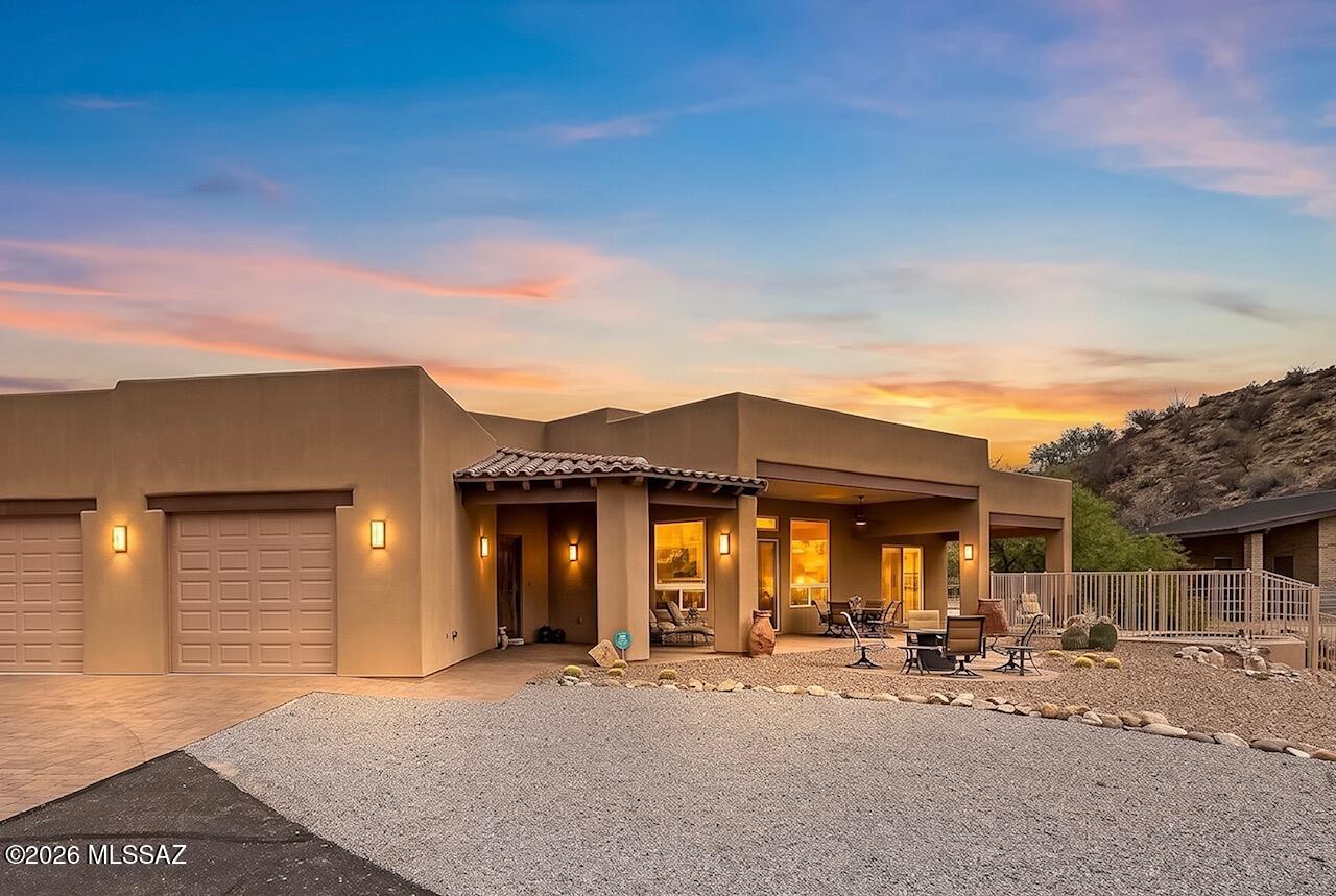 Set behind a private gate just beyond the community of Saddlebrooke, but with no HOA, this single-story custom home offers a rare combination of refined living spaces and thoughtfully designed equestrian amenities.
Inside, high ceilings, solid alder interior doors, a stone fireplace, and rustic finishes create a residence defined by craftsmanship and enduring materials. Focused around the panoramic view of the Catalina Mountains, this home is perfectly positioned to enjoy the leisure of ranch life in a luxurious manner.
The gourmet kitchen is designed for both everyday living and entertaining, featuring granite countertops, a gas cooktop, custom range hood, warming drawer, and generous workspace. A wet bar with beverage fridge and ice machine complete the space. A large laundry room, dedicated storage room, and extensive garage cabinetry are complemented by a secondary utility sink and additional washer in the garage, offering exceptional functionality.
The primary suite includes two walk-in closets, separate vanities, a private water closet, and a spacious curbless shower. Each secondary bedroom features its own en-suite bathroom and sliding glass doors opening directly to the exterior, creating privacy and an easy connection to the surrounding outdoor spaces. 
The split-bedroom floor plan provides privacy, while a combination of stone flooring and strategically placed carpet (primary suite & media room) brings warmth and texture to the interior. The second primary suite offers resort style accommodations, including a kitchenette, built in desk, living area, spacious bathroom, and private patio.
The property is equally well suited for equestrian use, or a hobby farm, with an exquisite masonry stable offering three stalls, a tack room, and a three-quarter bathroom, along with a large fenced paddock, shade structures, and a dedicated wash station.
Outdoor living centers around an expansive covered porch and heated spa, providing comfortable spaces to relax while taking in the surrounding property.
Combining quality construction, practical amenities, and a setting designed to fully enjoy the beauty and abundance of the Sonoran Desert. This property offers a distinctive opportunity for those seeking space, privacy, and flexibility without the restrictions of an HOA, just minutes to numerous golf courses, Miraval Spa, and the Mountain View Country Club.