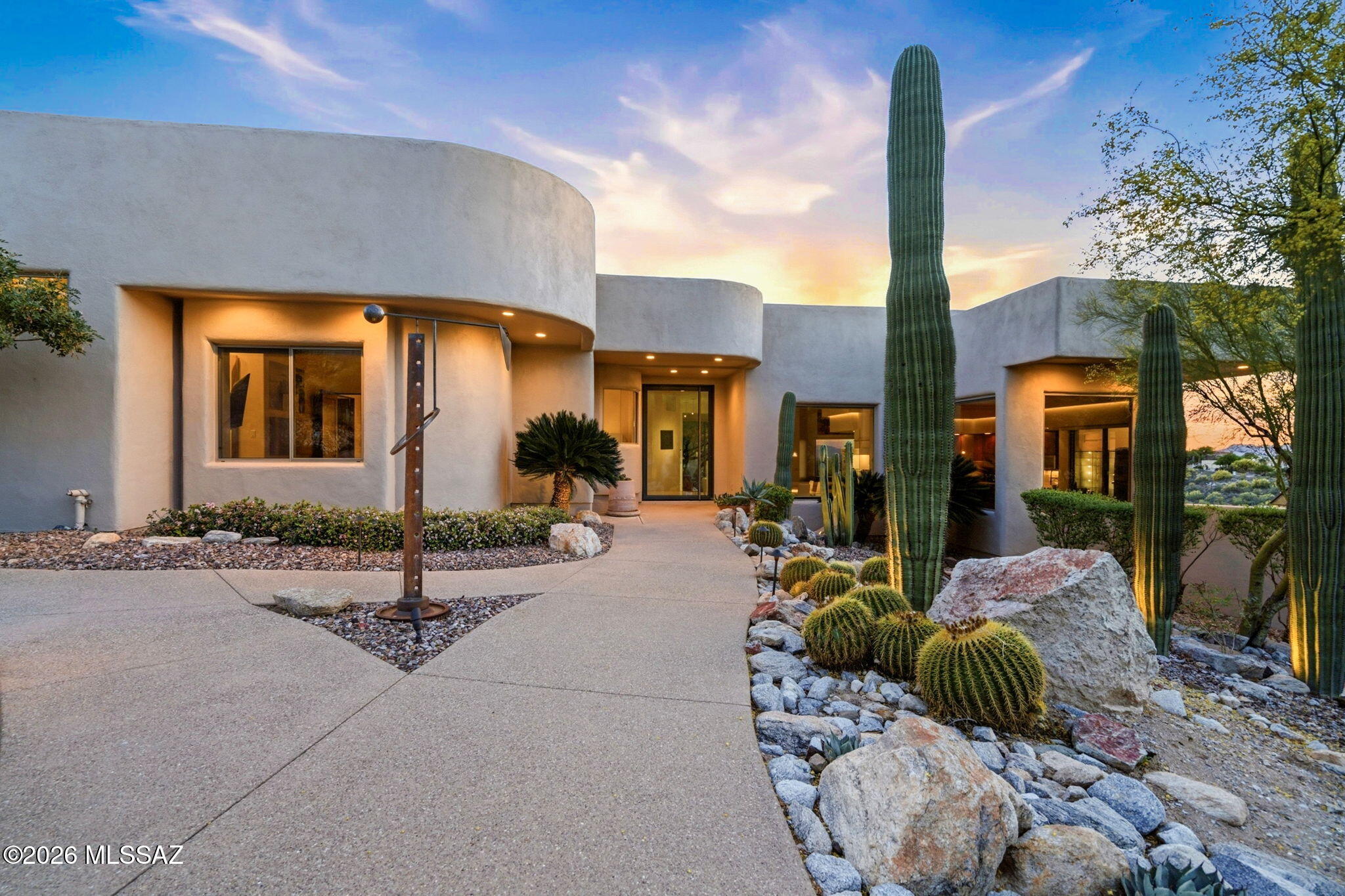 **TAR HOME TOUR WINNER** This means this home was selected as the best on the tour by other licensed agents! 
Perched on a prime 1.134-acre corner lot, this fully renovated luxury retreat delivers jaw-dropping 360° city views and breathtaking Catalina Mountain vistas. Evenings sparkle with city lights while you unwind in the infinity-edge pool or spa-like hot tub. Inside, modern elegance meets warmth with live-edge mesquite shelving, custom etched wood accents, and sun-filled oversized windows. The chef's kitchen boasts quartz countertops and high-end appliances. Impeccable landscaping, perfect irrigation, a spacious 4-car garage, and thoughtful upgrades like an in-home vacuum system complete the package. 3 beds, 2.5 baths--this is desert luxury at its finest. See the documents section for many of the immaculate upgrades.