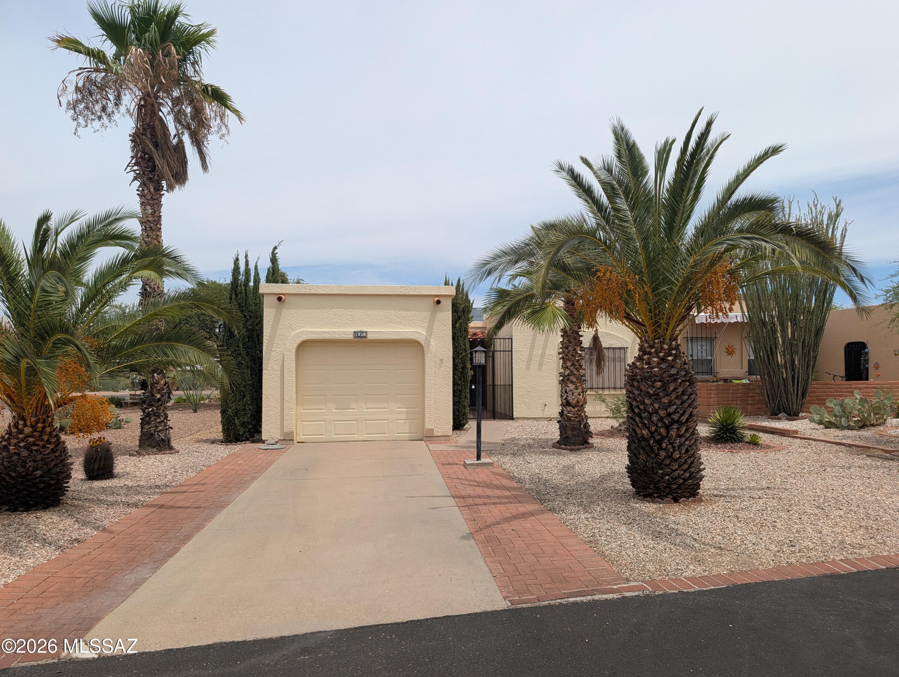 Welcome to this wonderful end unit townhome in Green Valley's Desert Hills. A 2 bed, 2 bath home offering 1,330 sq ft of living with a bonus office/workspace off the kitchen, a cedar-lined master closet with built-in safe, and a jetted tub in the bath. With its easy-care desert landscaping this low-maintenance retreat  is perfect for all year or seasonal living. As part of Green Valley Recreation, owners enjoy access to 13 recreation centers with pools, spas, fitness rooms, tennis and pickleball courts, and 60+ social clubs. Minutes from Camino Del Sol shopping, dining, and the Santa Rita Mountains. Schedule a showing today!