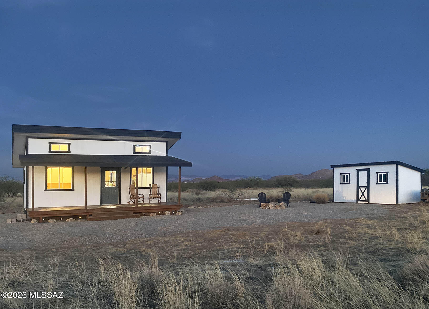 Nearly new (built 2025) off-grid tiny home on 1.7 acres with outstanding Dragoon Mountain views. The 384 sq ft cabin (24' x 16') features a large 8' x 24' covered porch perfect for enjoying desert sunsets and wildlife. Designed for comfortable off-grid living with solar power and battery storage, new septic system, storage shed, 2,200-gallon water storage tank with refill service, propane heat, on-demand hot water, propane range/oven, dual propane/electric refrigerator, and full-size washer & dryer. Interior includes custom knotty alder cabinets and a new bathroom with shower. 8' x 14' storage shed and furniture included. Corner lots on two county-maintained roads. No neighbors! A quiet high-desert setting ideal for a weekend getaways, country retreats, or full-time peaceful rural living.